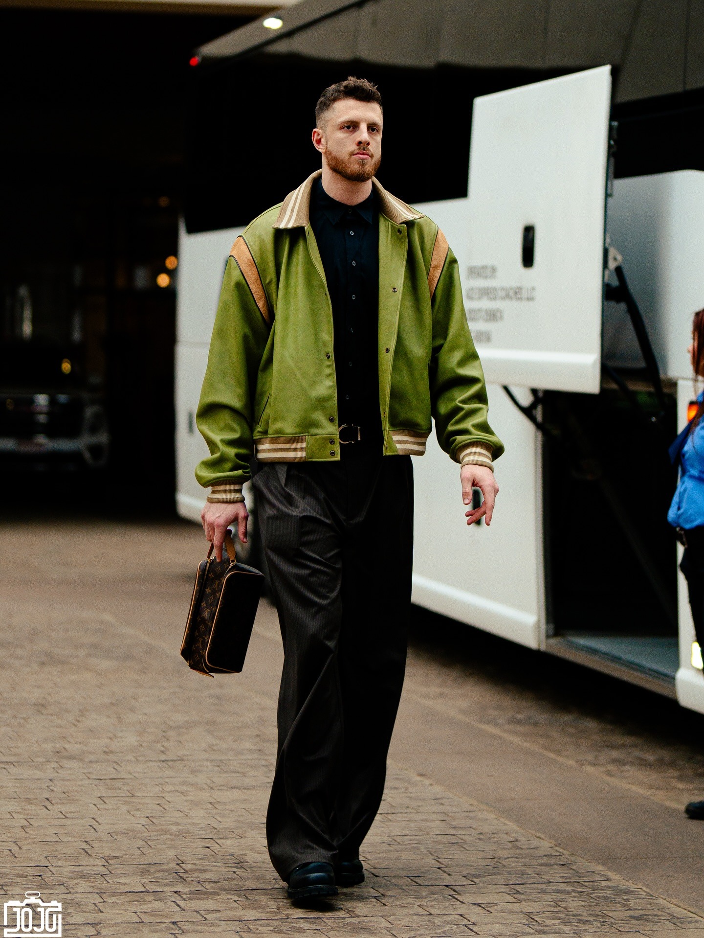 Isaiah Hartenstein wearing Elwood Insignia Jacket and Louis Vuitton Locker Dopp Kit.