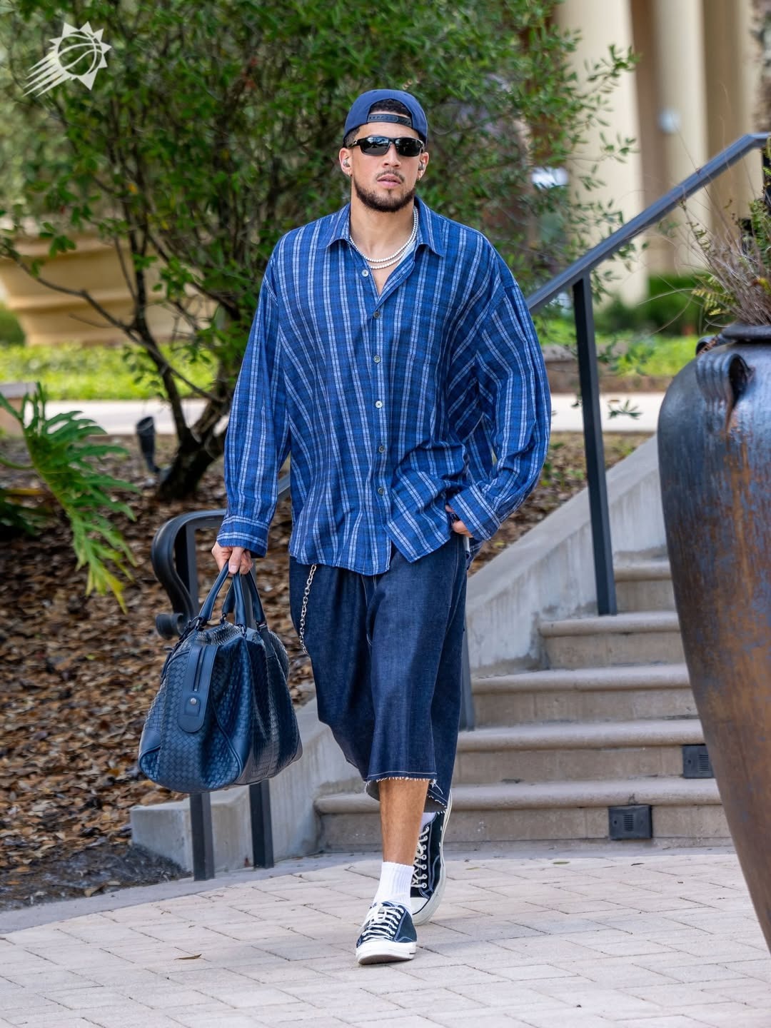 Devin Booker wearing Our Legacy Borrowed Shirt Check Please Print, Weekday Astro denim loose baggy shorts blue rinse dark blue and Converse Converse All Star.