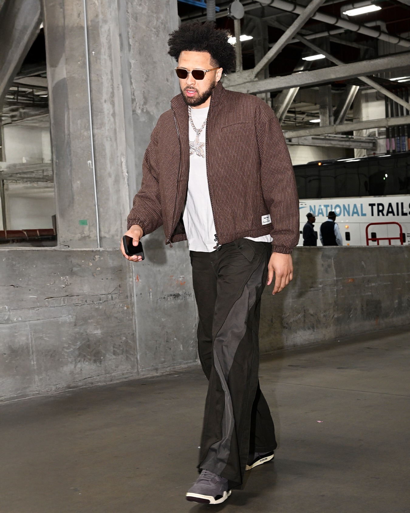 Cade Cunningham wearing Nude Project Wool Zip-Up Bomber Jacket Brown, FFFPOSTALSERVICE 3-Way Zip Cargo Trousers in Black and Nike Air Jordan 4 x A ma maniere.