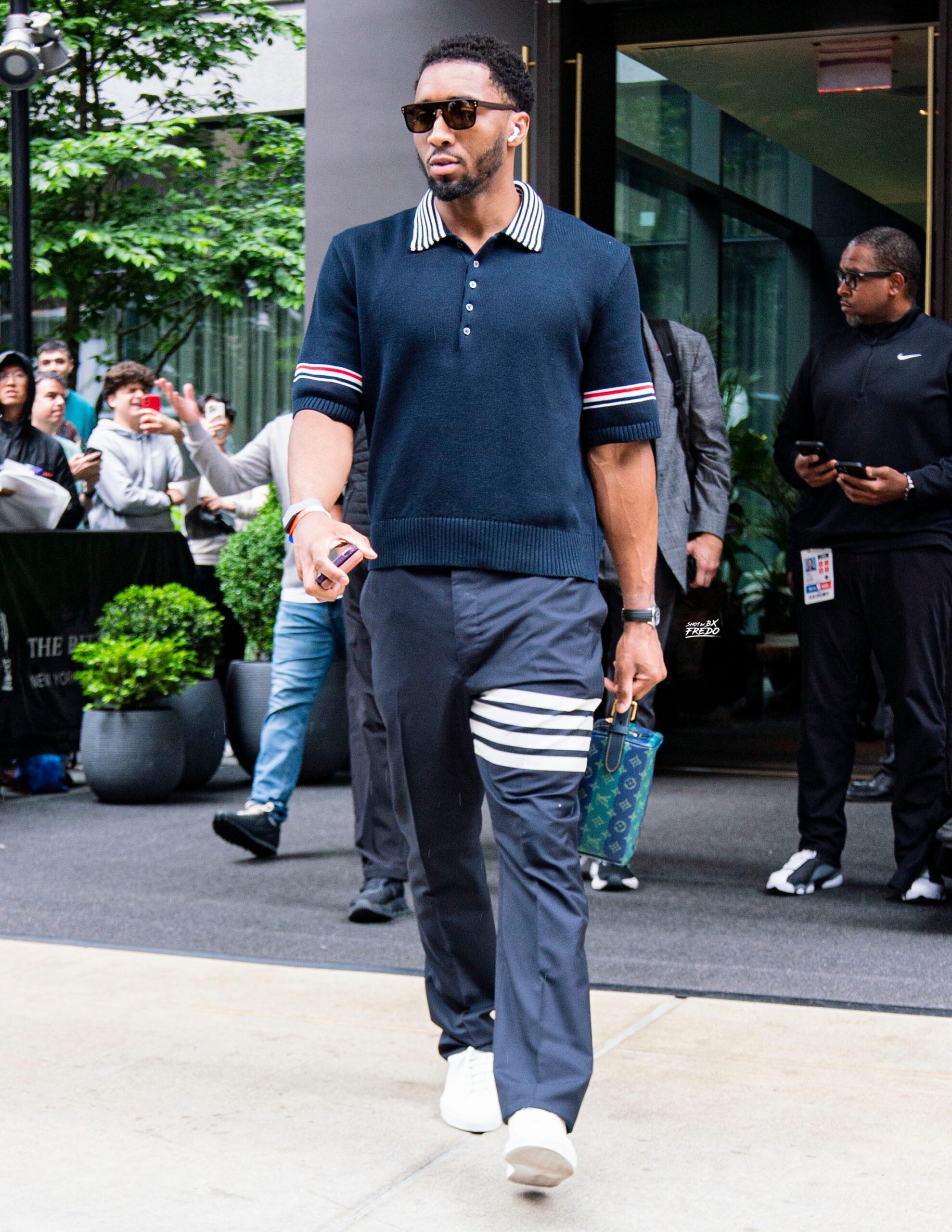 Donovan Mitchell wearing Thom Browne Rwb Armband Sailboat Rugby Polo and Thom Browne Plain Weave 4-Bar Backstrap Trouser.