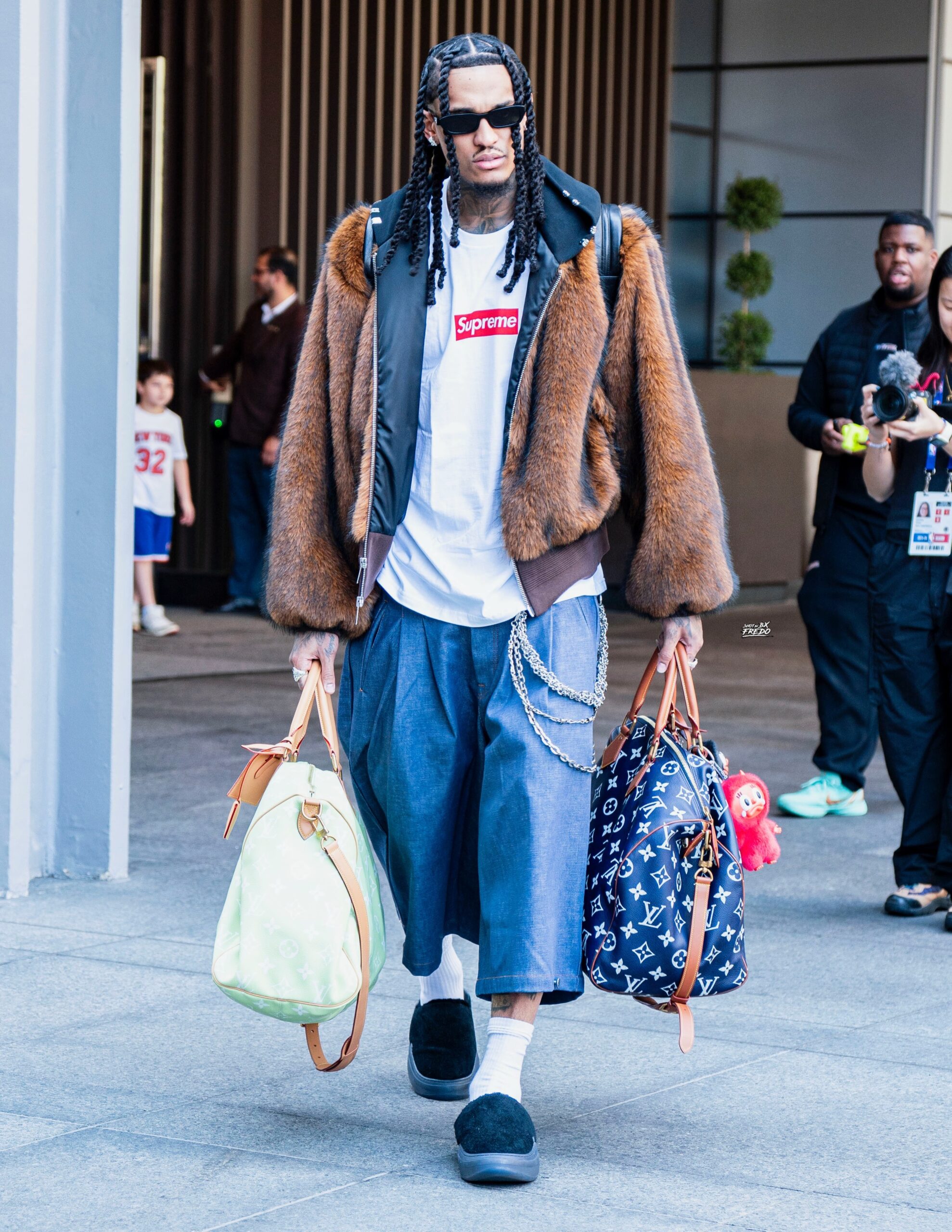 Jordan Clarkson wearing ALICE HOLLYWOOD MARILYN FUR BOMBER JACKET, mnml ULTRA BAGGY PLEATED DENIM SHORTS and ERL pirate black vamp mule.