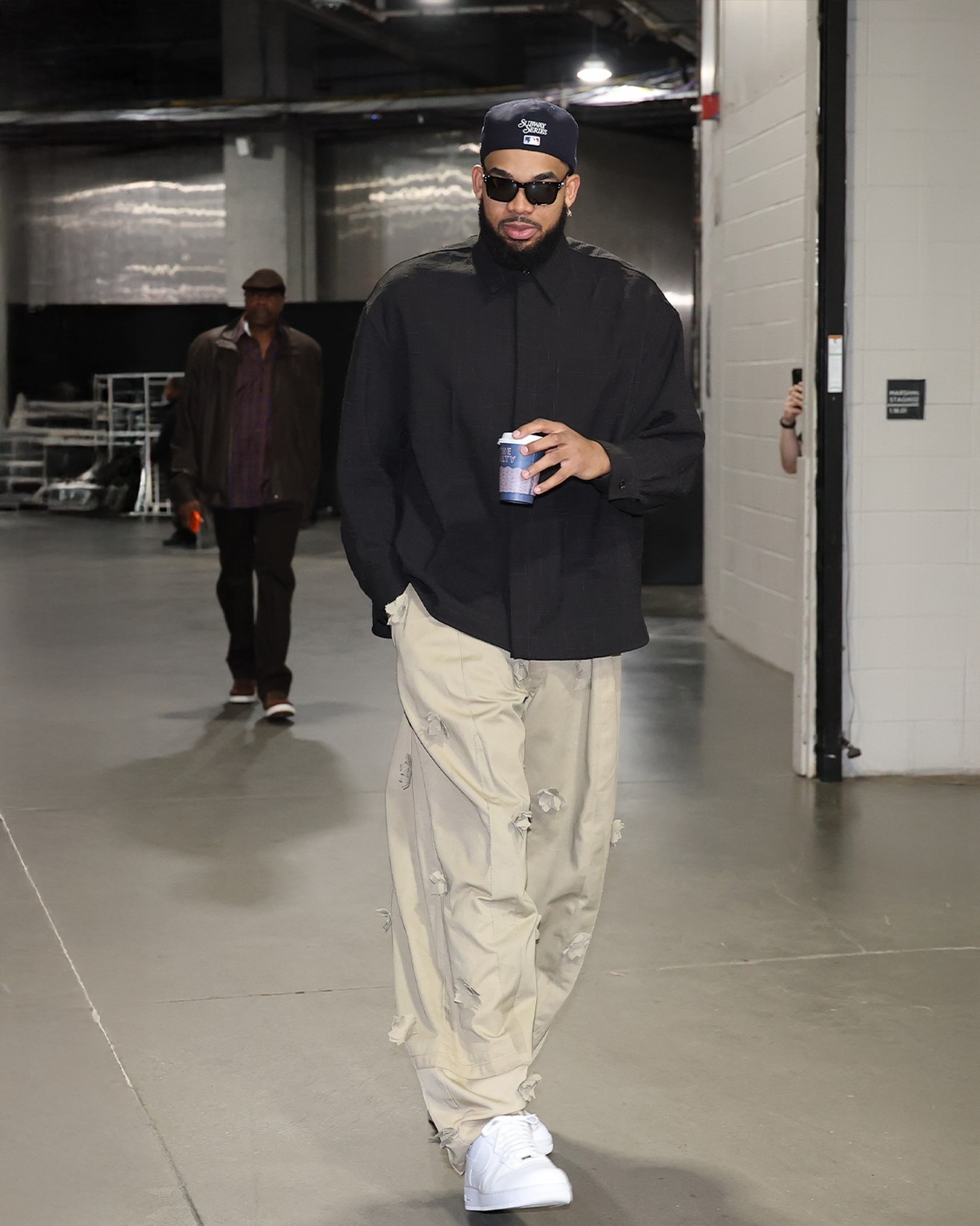 Karl Anthony Towns wearing Bottega Veneta Men’s Wool Twill Shirt in Black, Joshua Samuels FO Baggy Trou – Beige – Limited Mono Petal Edition.