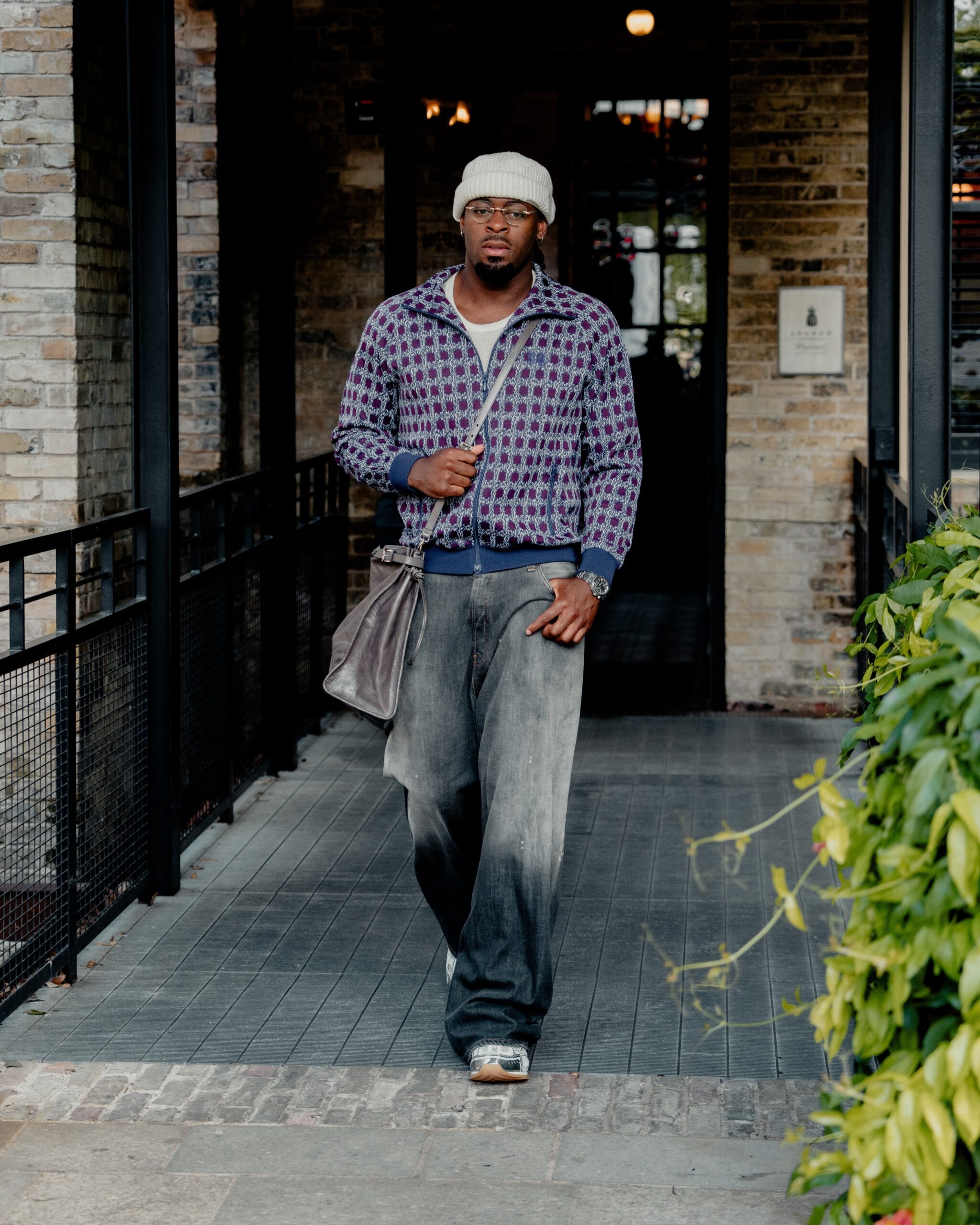 Luguentz Dort wearing Needles zip jacket, Acne Studios Loose fit jeans – 2006M and Prada Prada Bonnie large leather handbag.