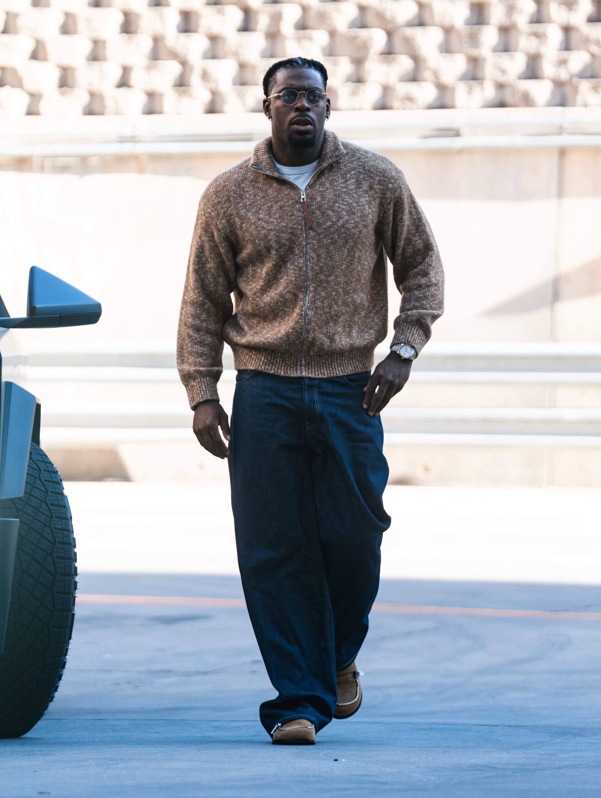 Luguentz Dort wearing Loewe Zip-up cardigan in cotton, linen and wool, Carhartt Blue Brandon Jeans and JW Anderson Tan Biker Loafers.