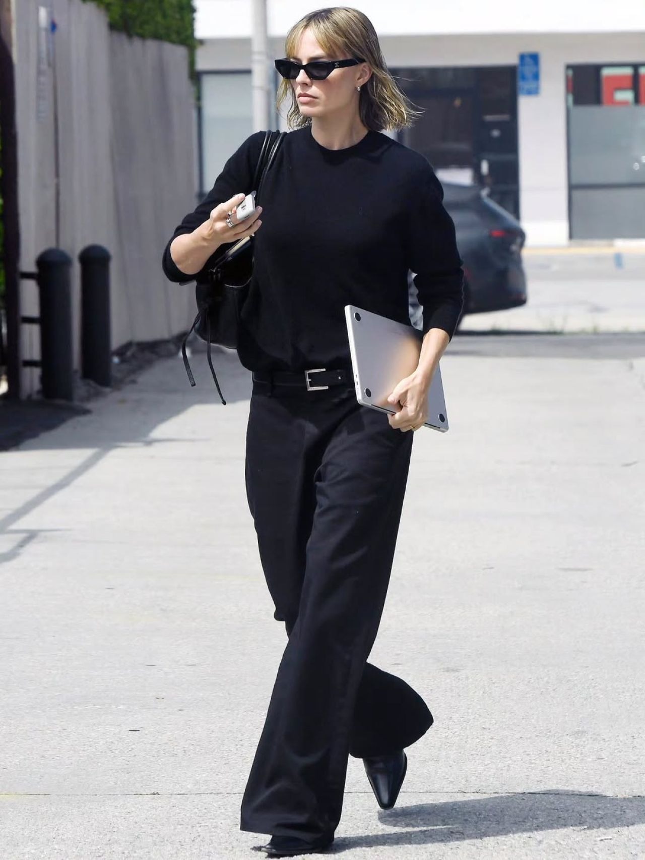Margot Robbie wearing Saks Fifth Avenue Cashmere Crewneck Sweater and Acne Studios Satin trousers.