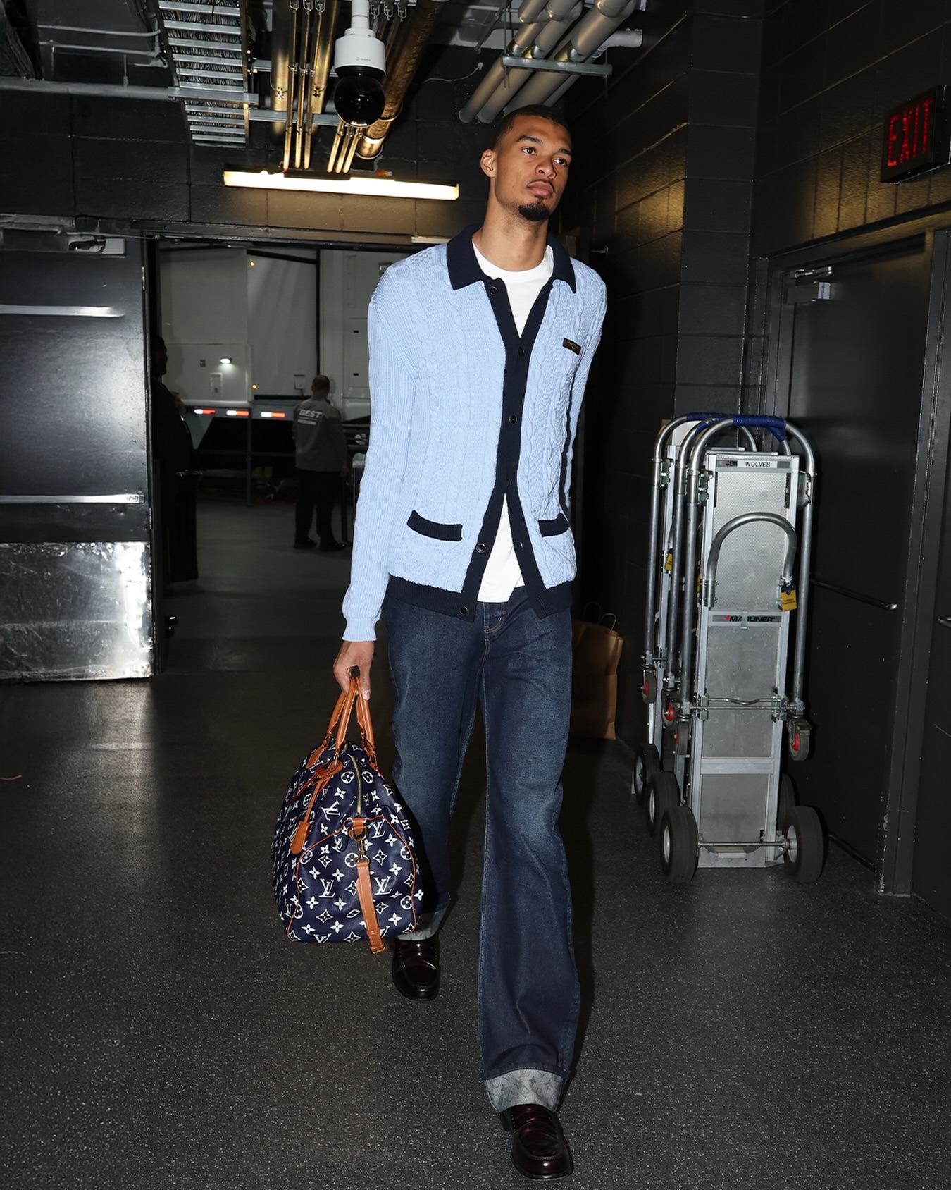 Victor Wembanyama wearing Louis Vuitton Cable-Knit Shirt Cardigan, Louis Vuitton Signature Turn Up Denim Skate Pants and Sebago Classic Dan – Brown.