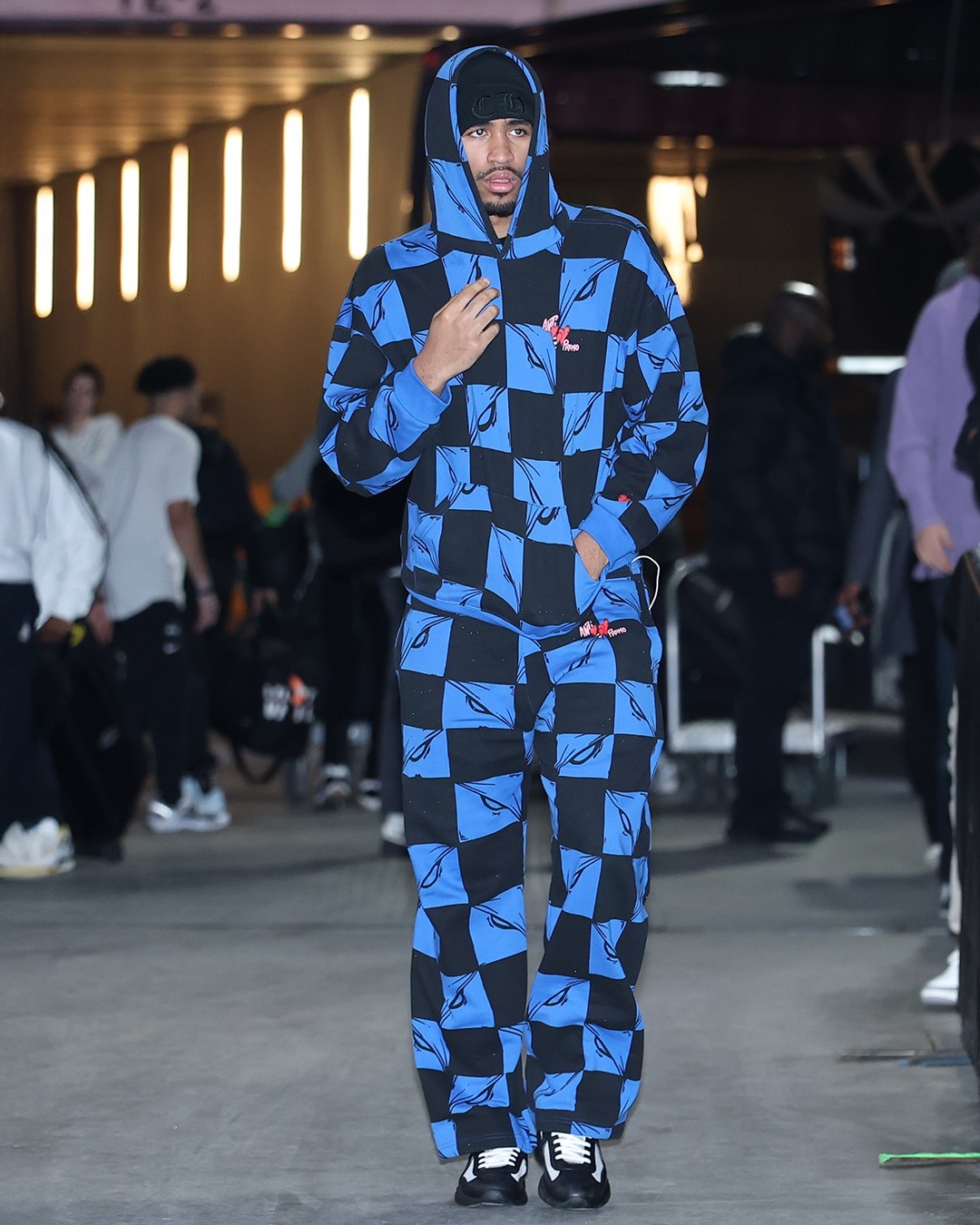 Dylan Harper wearing Matty Boy Anti Promo 99 Eyez Hoodie ‘Black/Blue’, Matty Boy Anti Promo 99 Eyez Sweatpants ‘Black/Blue’ and Prada.