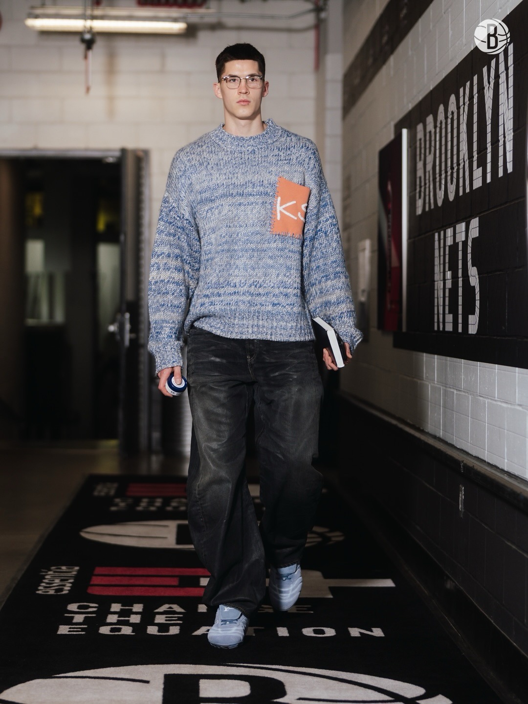 Egor Demin wearing KidSuper Studios Chunky sweater blue, Diesel 1997 Denim-m-uc jeans and Louis Vuitton Lv footprint soccer sneaker silver.