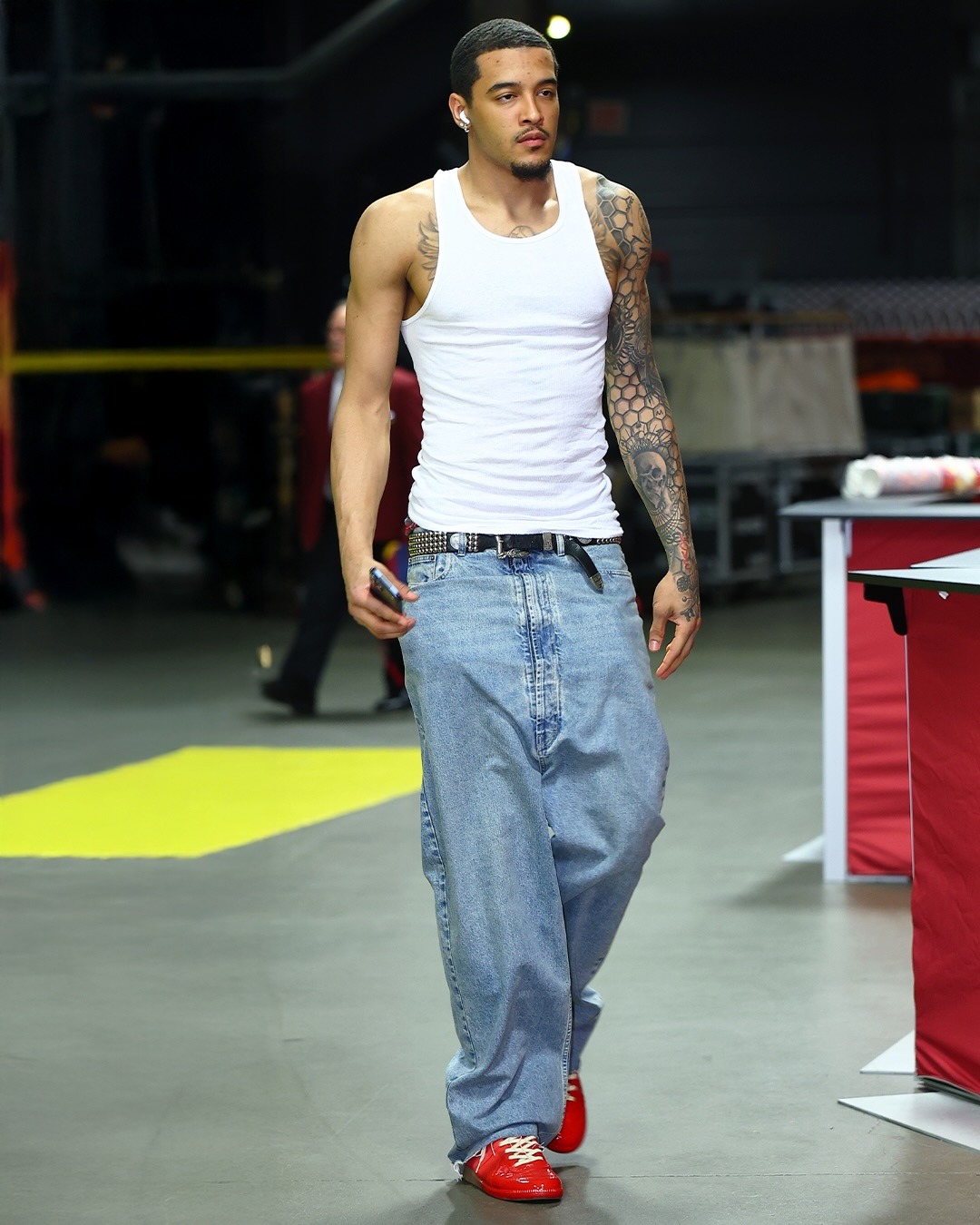 Jeremy Sochan wearing Calvin Klein 3-Pack cotton ribbed tanks, Maison Margiela Dropped-rise denim jeans and Maison Margiela Sneakers replica in red leather.
