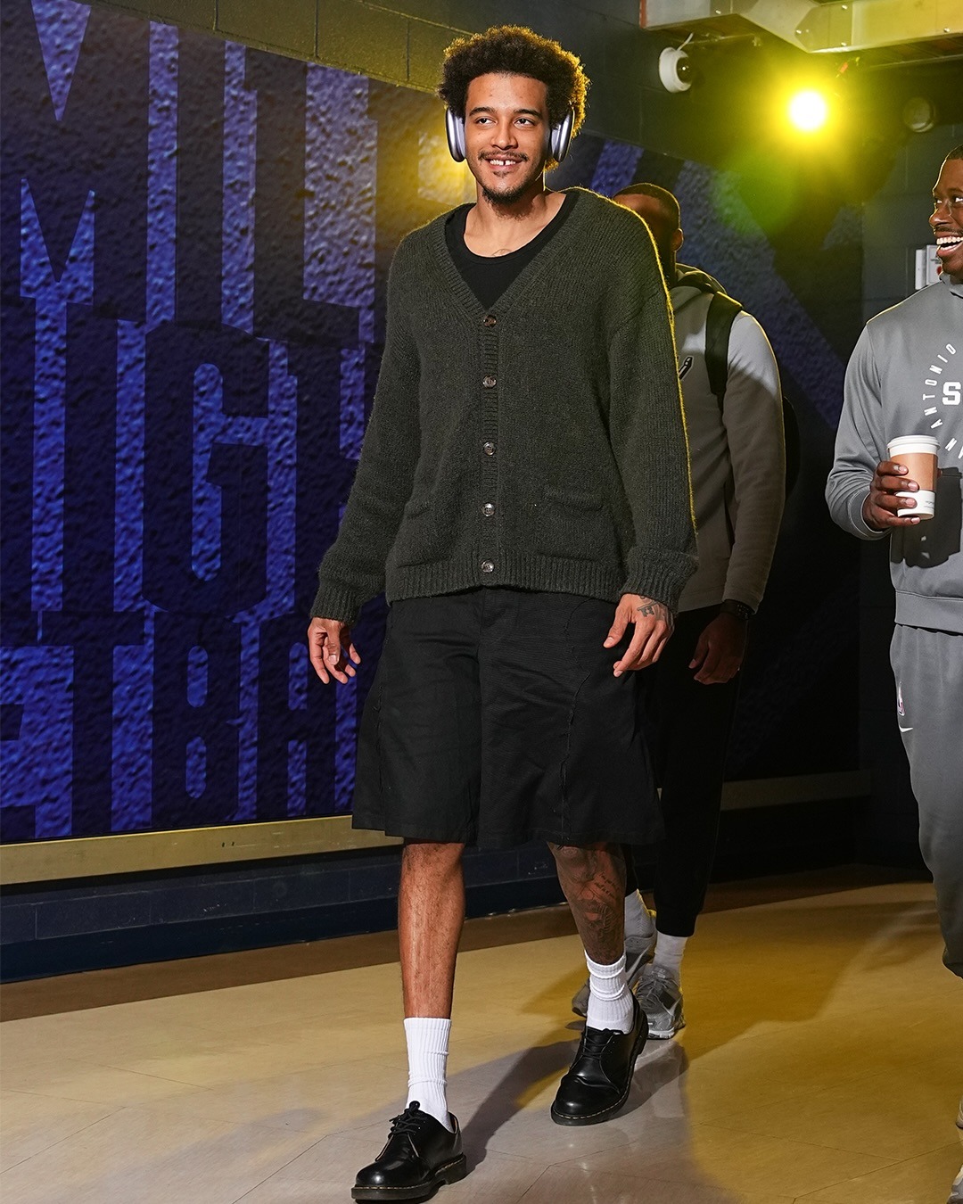 Jeremy Sochan wearing Vetements Vetements Oversized Baby Alpaca Blend Cardigan, Carhartt Double knee short black (stone washed) and Dr. Martens Dr martens.