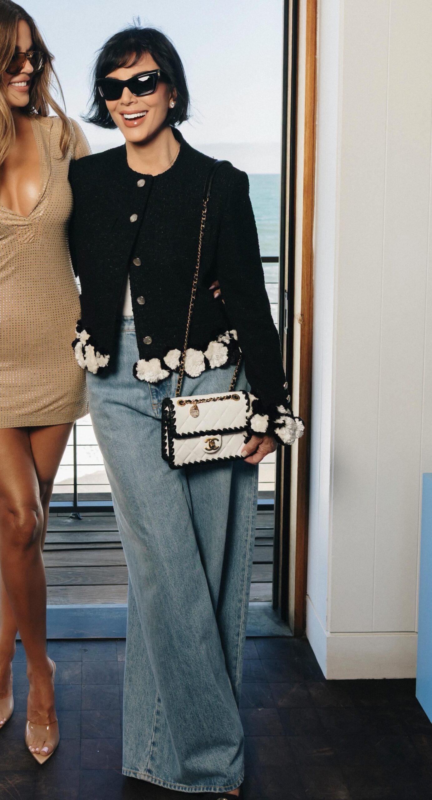 Kris Jenner wearing Chanel Jacket, Cotton & Mixed Fibers Black & White – Summer 2026 and Chanel Mini flap bag, Braided Calfskin &.