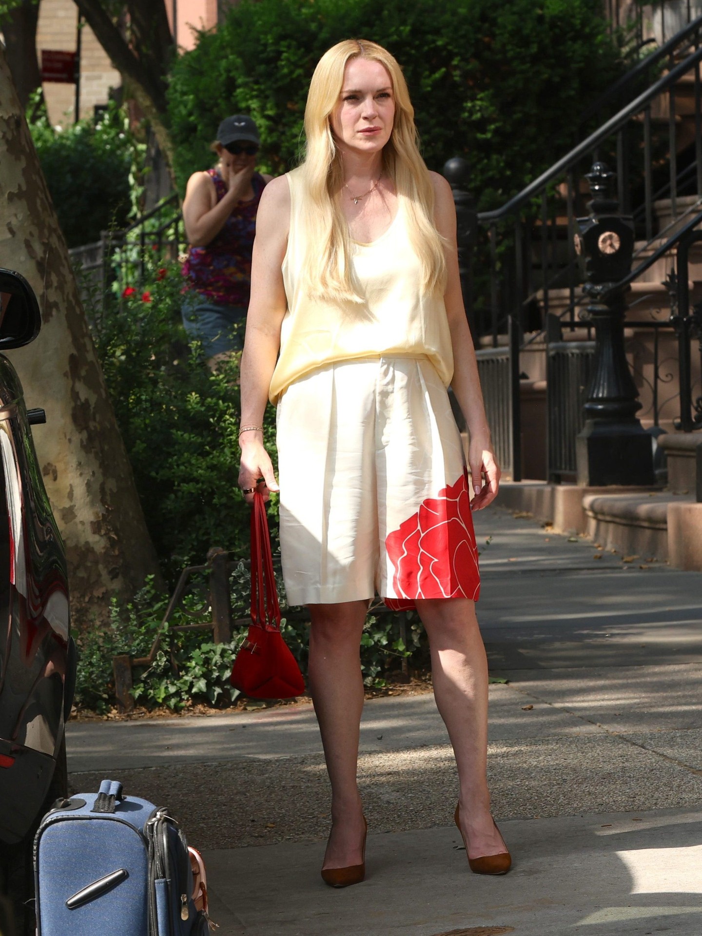 Lindsay Lohan wearing Twinset Shiny Vanilla/yellow satin top, Victoria Beckham Floral-print tailored shorts and Manolo Blahnik Bb 90 Brown Suede Pointed Toe.