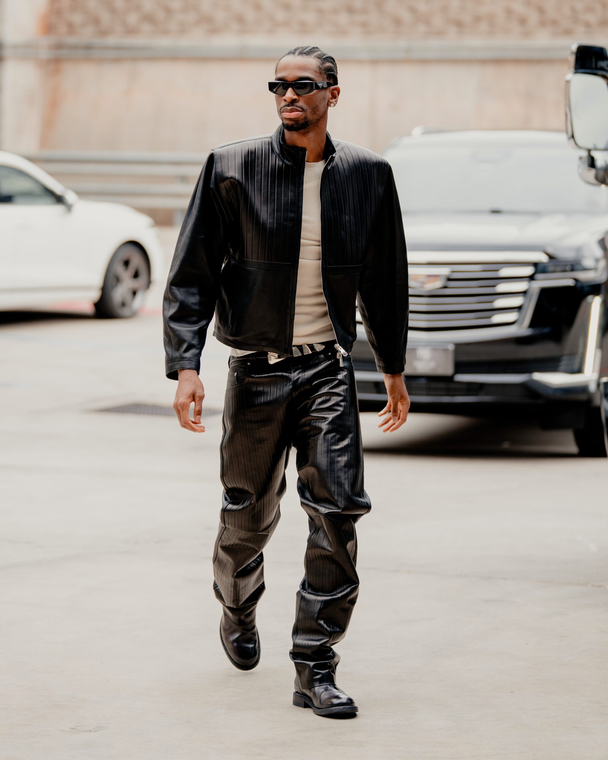 Shai Gilgeous Alexander wearing VERSACE Leather Blouson, VERSACE Embossed Leather Pants and VERSACE V Leather Chelsea Boots.