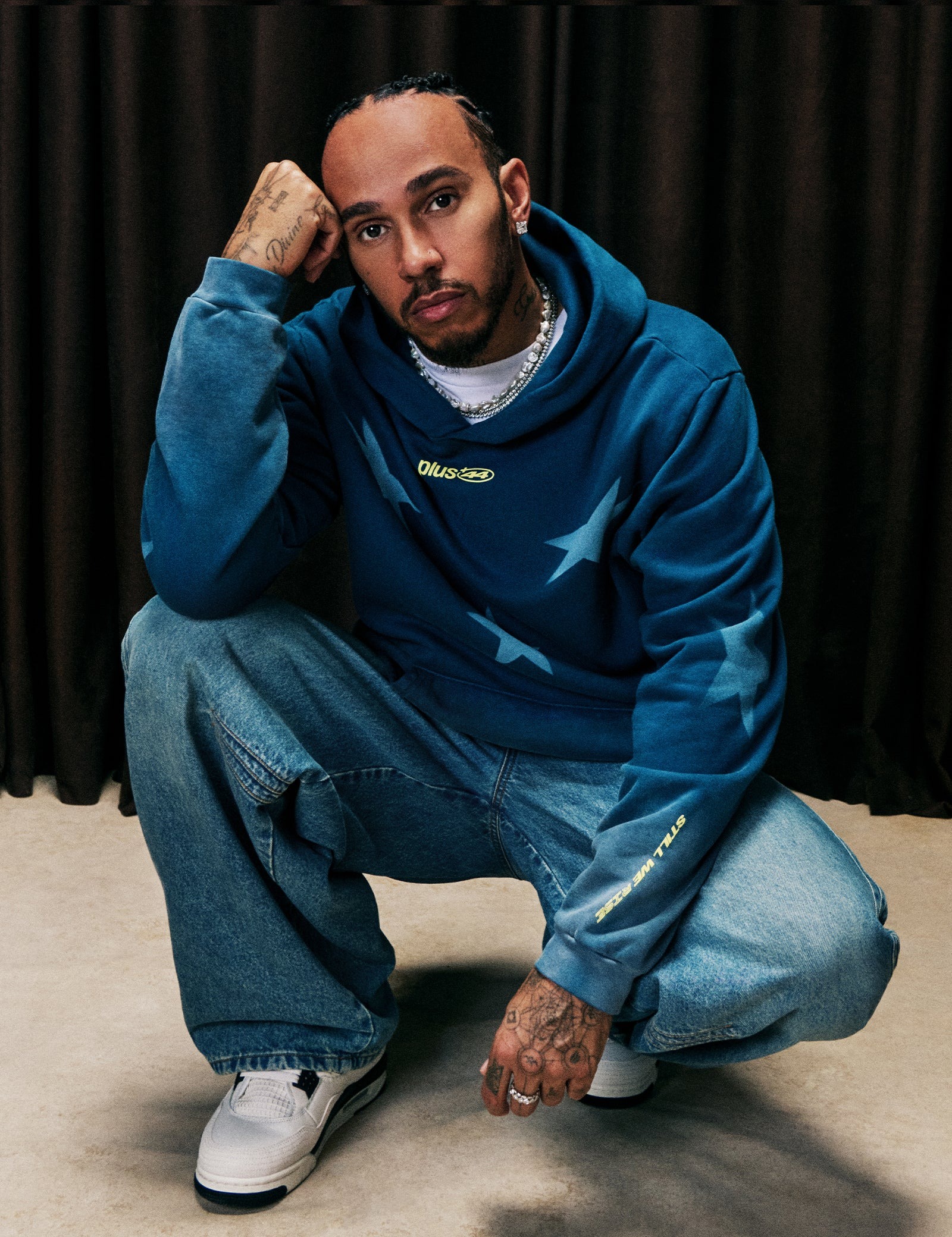 Lewis Hamilton wearing Plus 44 Sun fade star hoodie – midnight blue, Levi’s Twisted baggy wide leg men’s jeans and Nike Men’s air.