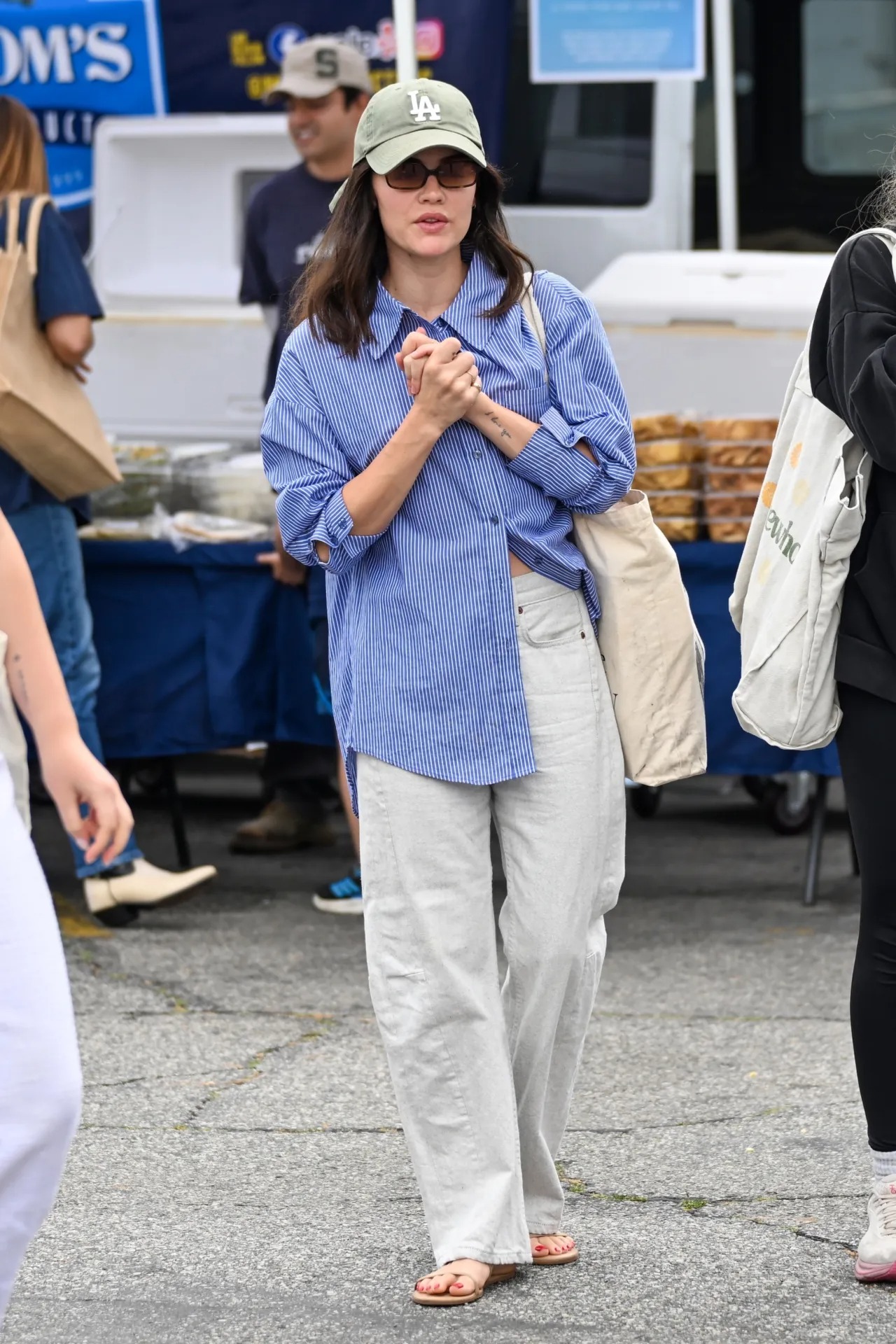 Lucy Hale wearing The Frankie Shop Georgia boxy shirt – white/blue stripe, Frame The bow high rise wide leg jeans – light grey and Journee.