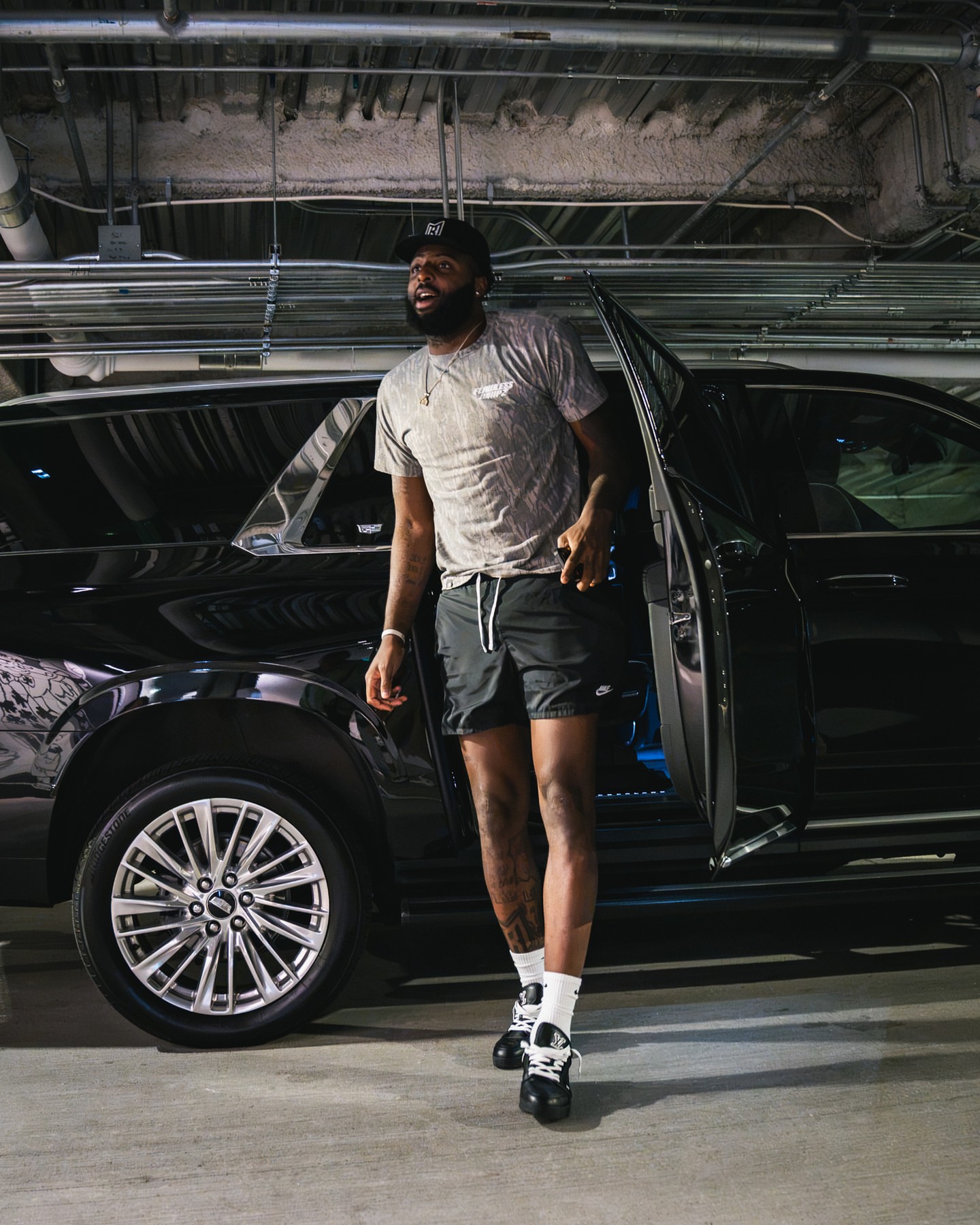 Mitchell Robinson wearing Flawless Whipz Mossy oak tee – Grey, Nike Nike Woven Lined Flow Shorts ‘Black’ and Louis Vuitton Lv trainer.