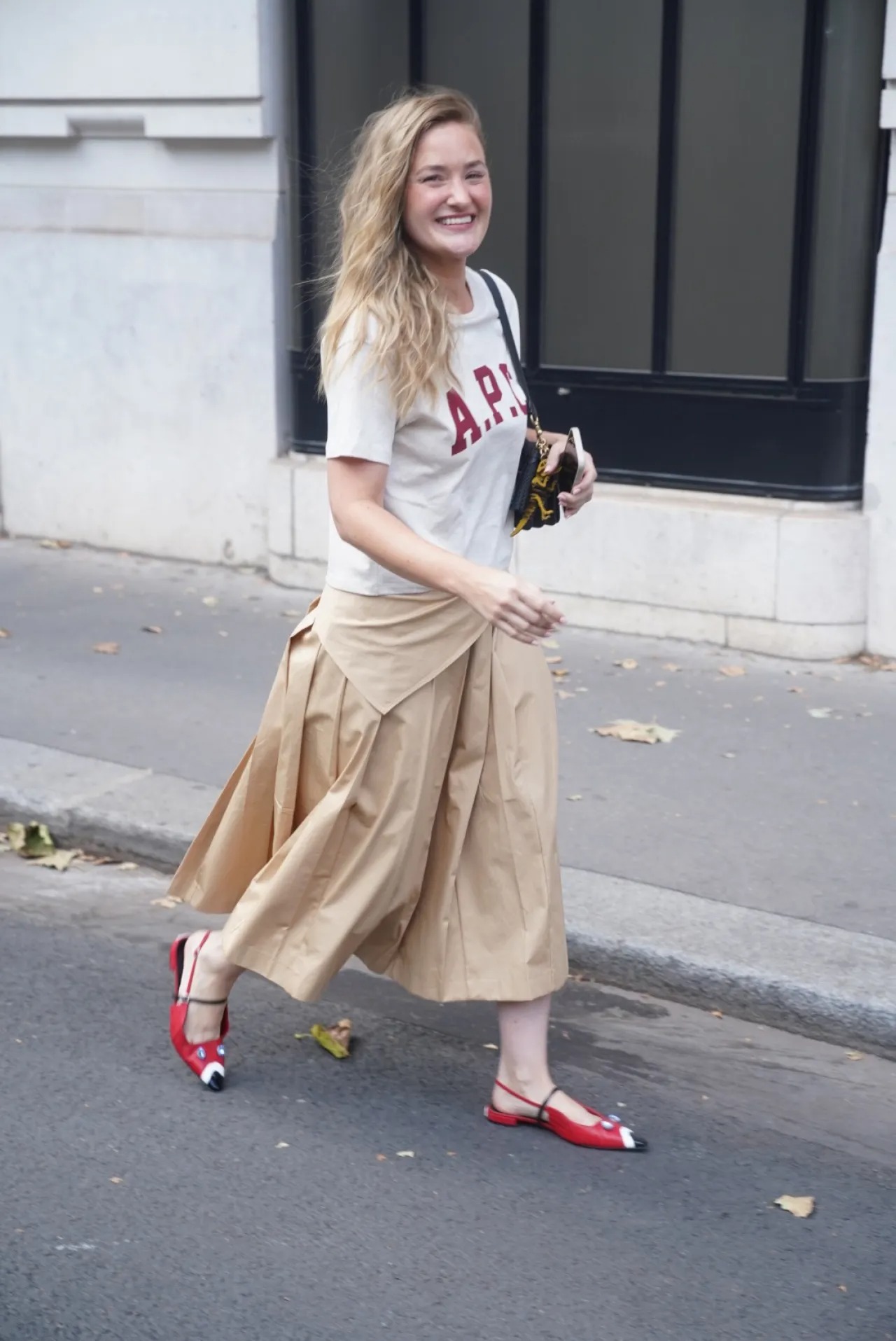 Aj Michalka wearing A.P.C. Logo-print cotton t-shirt red and white, Claudie Pierlot Claudie pierlot cotton pleated midi skirt beige and Carel Pigeon p –.