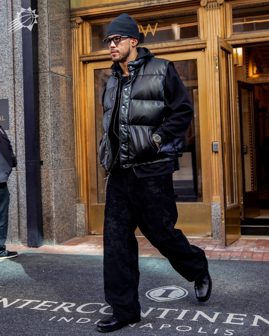 Devin Booker wearing Schott 204Dv Down Filled Lambskin Vest Black, Our Legacy Vast cut coated cord pants black and Lemaire Zipped boots in Soft Calfskin.