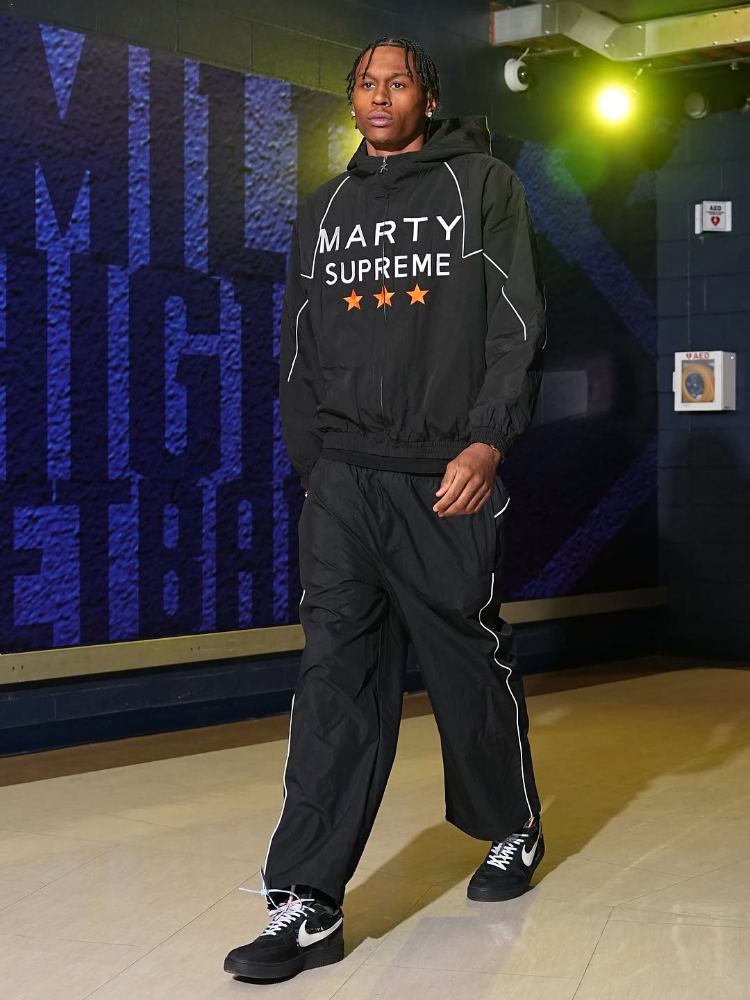 Peyton Watson wearing Nahmias Nahmias X marty supreme star-print sport jacket, Supreme Supreme contrast piping track pant black and Nike X Off-White The 10:.