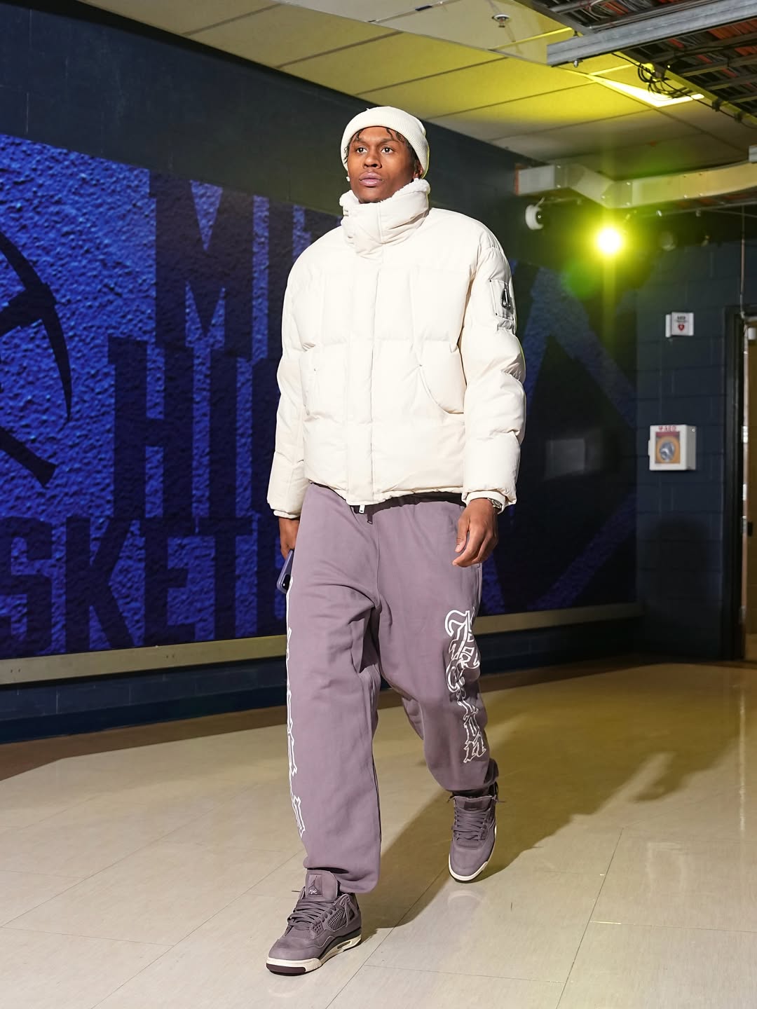 Peyton Watson wearing Moose Knuckles Everest puffer jacket, Heron Preston Gothic Heron Ctnmb ‘Grey White’ and Jordan Jordan X A ma maniere air.