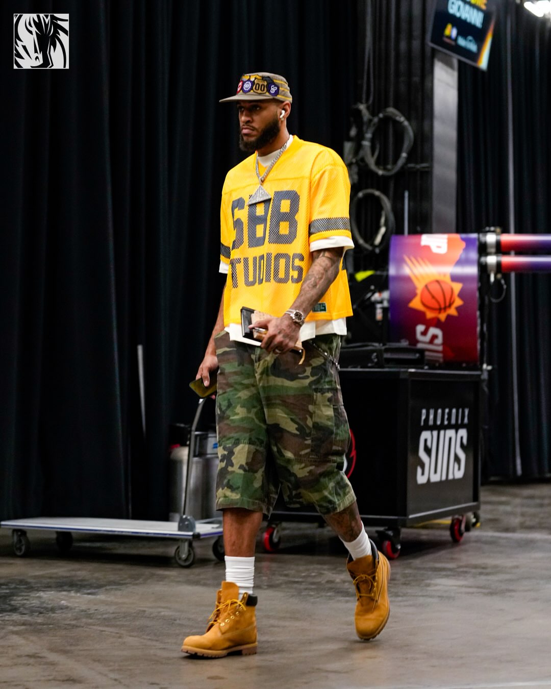 Daniel Gafford wearing Scary But Beautiful Sbb studios mesh” jersey yellow, mnml Extra long cargo shorts camo print and Timberland Men’s.