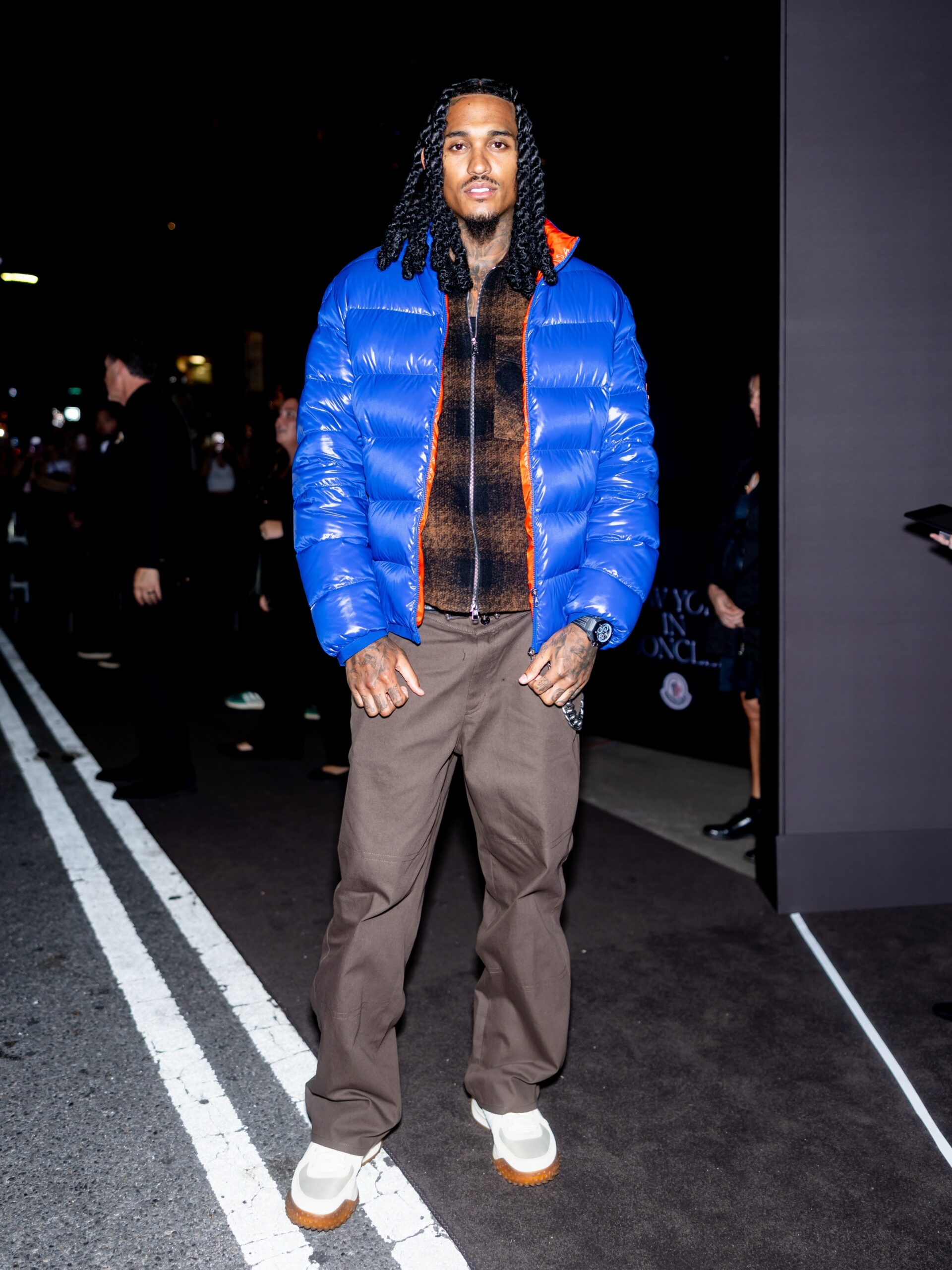 Jordan Clarkson wearing Moncler Check jersey zip-up shirt jacket brown and black, Moncler Stretch gabardine pants Grey and Moncler Moncler citytrek sneakers.