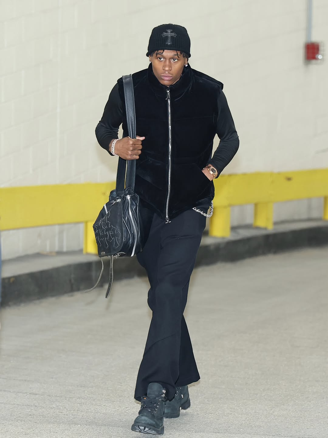 Peyton Watson wearing Maniere De Voir Manu in black – velvet puffer gilet, Chrome Hearts Cross patch knit black beanie and Timberland Men’s.