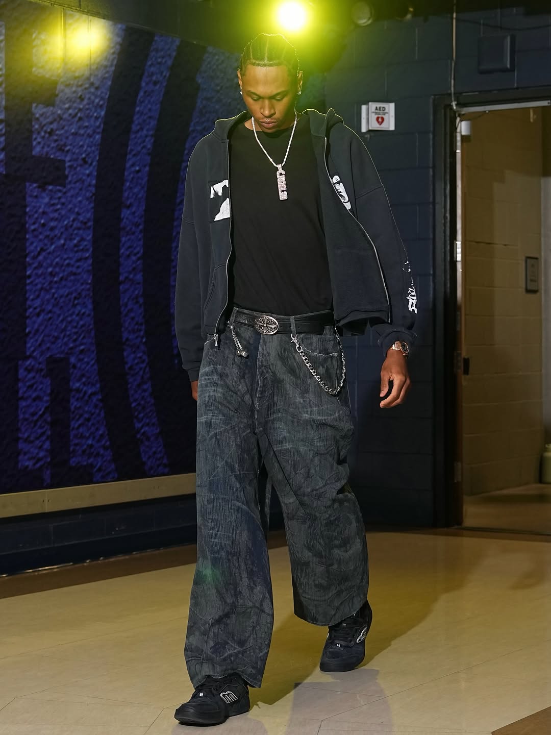 Peyton Watson wearing Enfants Riches Deprimes Enfants Riches Deprimes Gas Mask Patchwork Zip Up Hoodie Navy, Balenciaga Balenciaga navy blue wide-leg jeans.