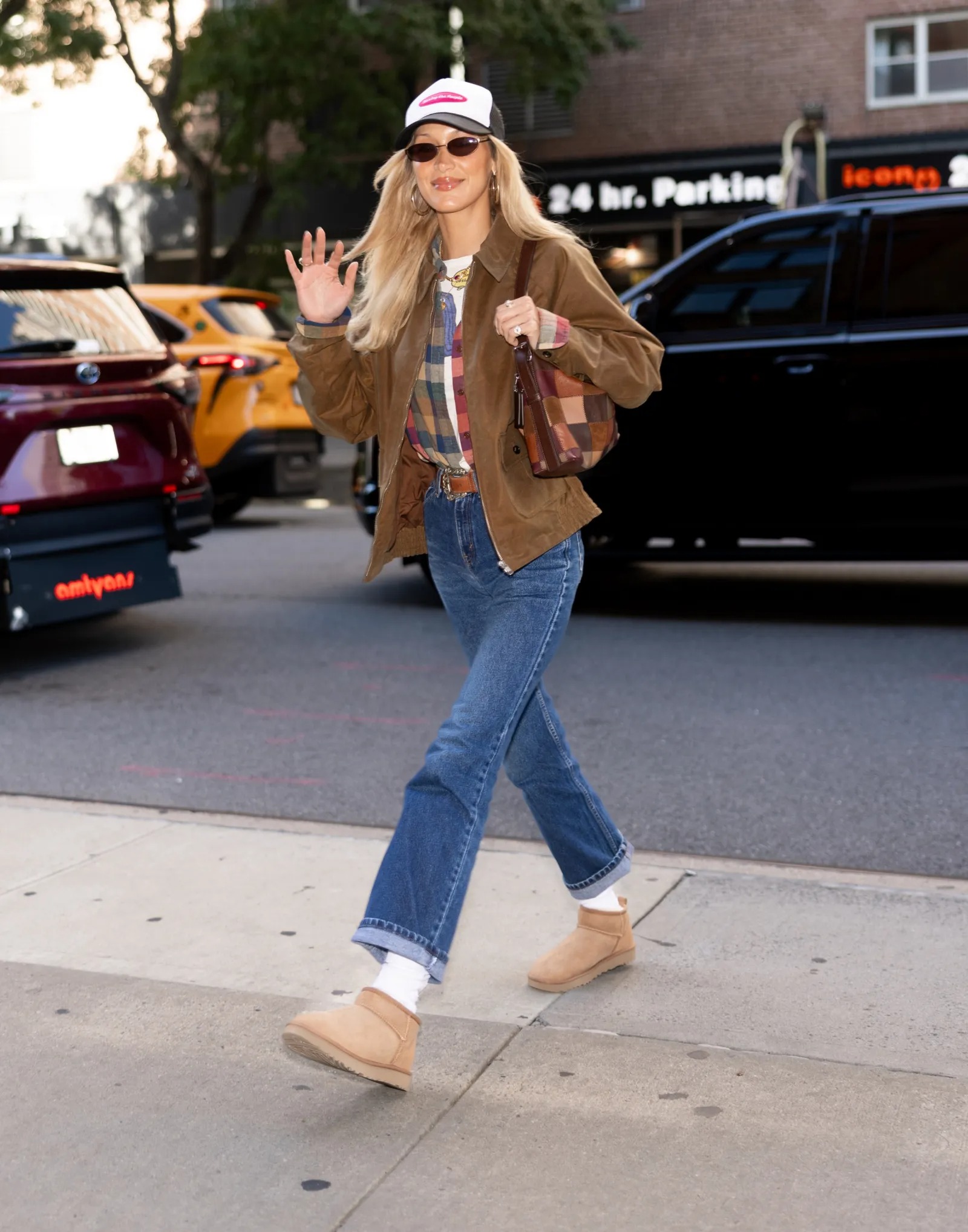 Bella Hadid wearing Nour Hammour Dalma suede jacket brown, Frame The essential mid rise straight jeans in lucky blue and Ugg Women’s classic mini ii.