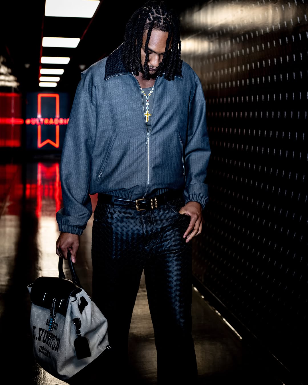 Devin Vassell wearing Bottega Veneta Intrecciato wool and mohair blouson jacket grey, Bottega Veneta Intrecciato leather straight pants black and Louis.