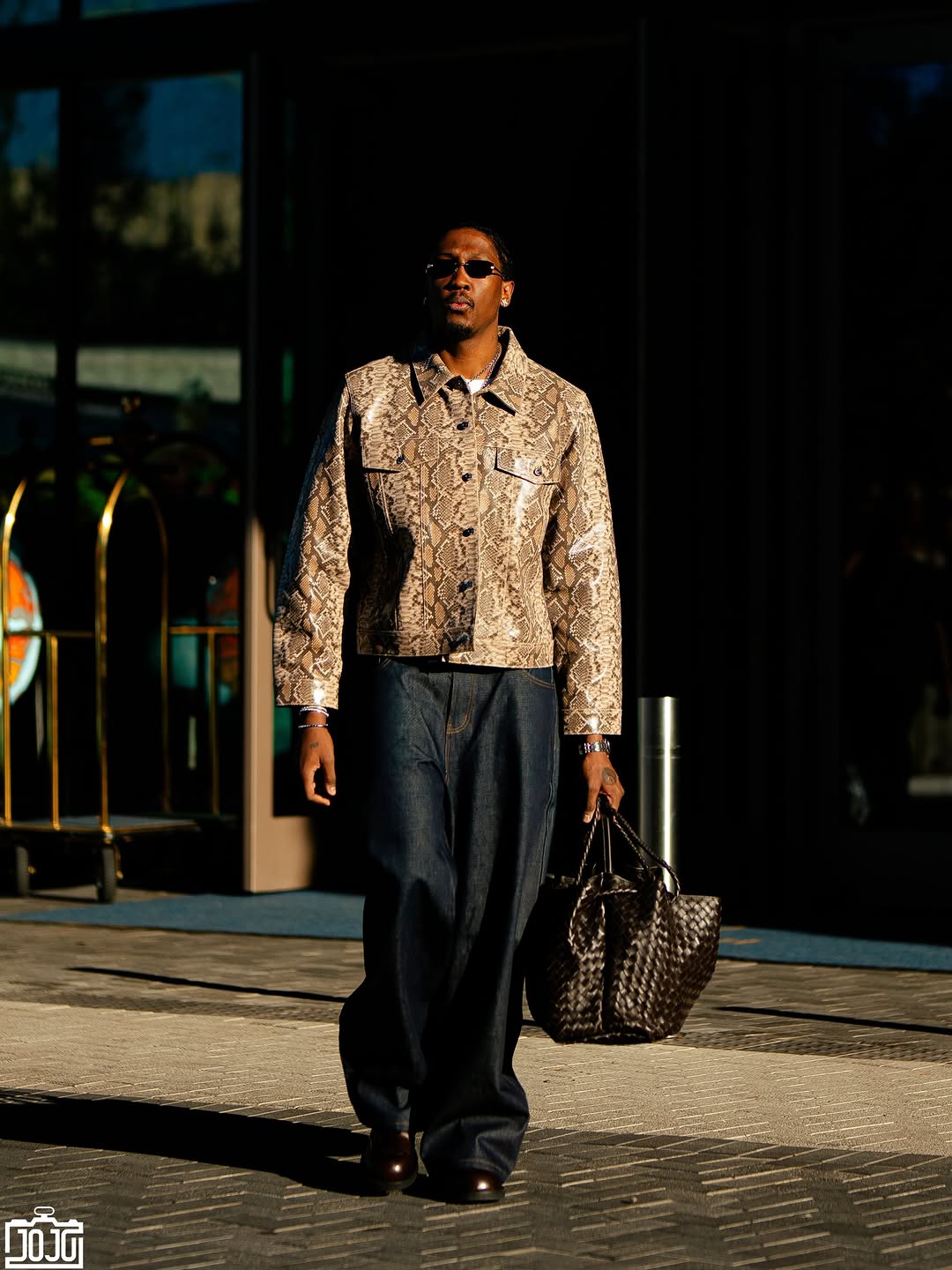 Jalen Williams wearing Midnight Rodeo Midnight rodeo leather trucker multicolor snake print, Acne Studios Loose fit jeans Low waist, baggy leg 1981 indigo.