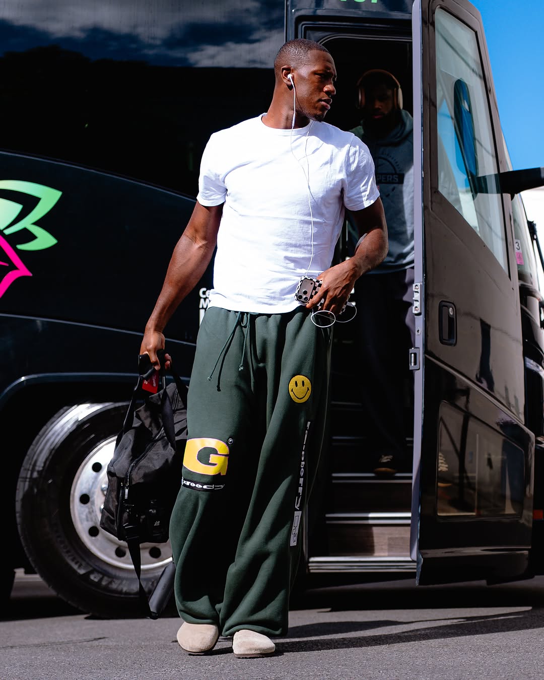 Kris Dunn wearing Calvin Klein Liquid touch crewneck t-shirt White, GV Gallery Greedy unit track pants dark green and Birkenstock Amsterdam wrapped suede.
