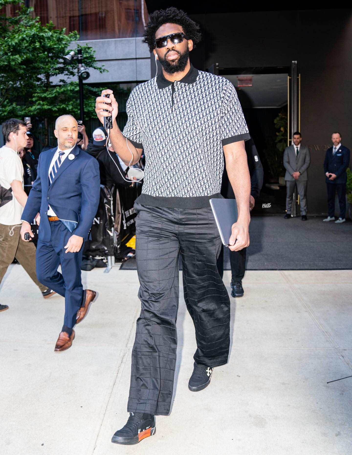 Joel Embiid wearing Dior Polo shirt, J.Lindeberg Glossa Padded Pants / Black and Off-White Off-White Vulc Low Top ‘Black’.