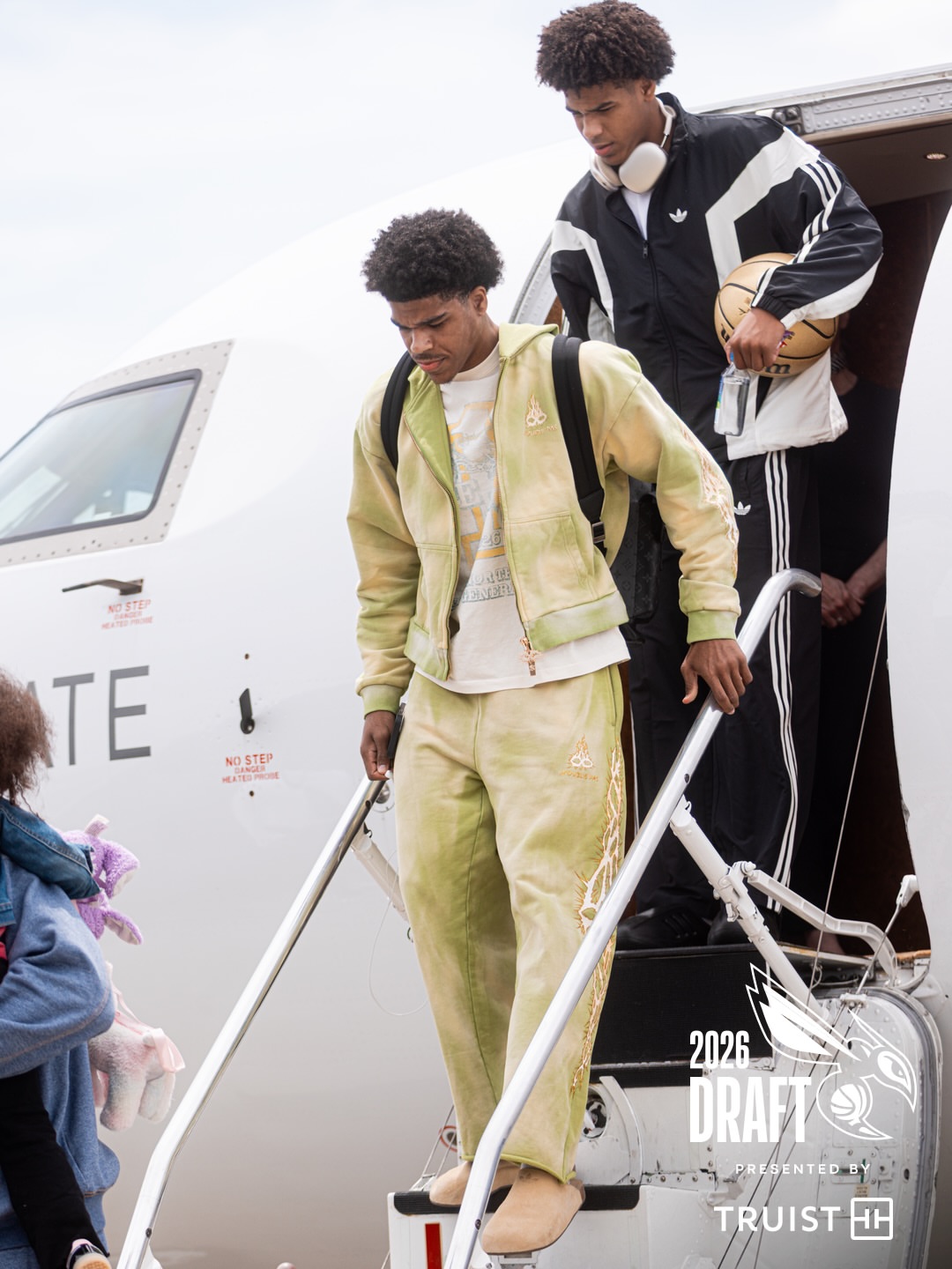 Christian Anderson wearing N’oublie pas Crown apple zip-up, N’oublie pas Crown apple sweatpants and Adidas Adimule slide – golden beige / gum.