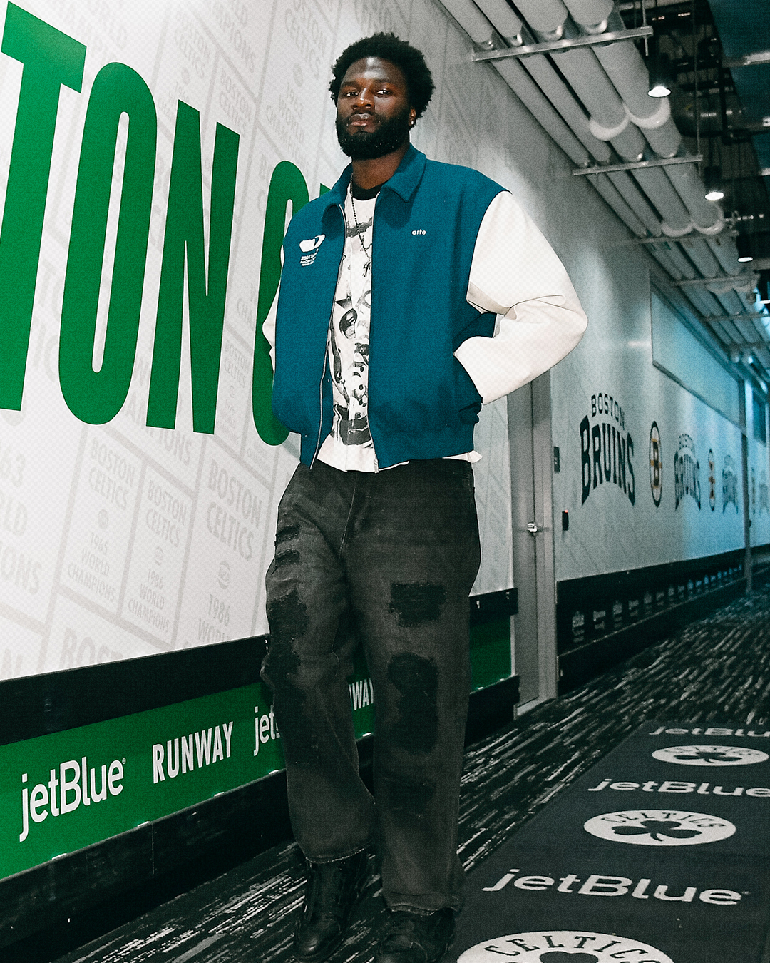 Neemias Queta wearing Arte Arte antwerp jonah team jacket – Green/light grey and Gallery Dept Branko carpenter – Black.
