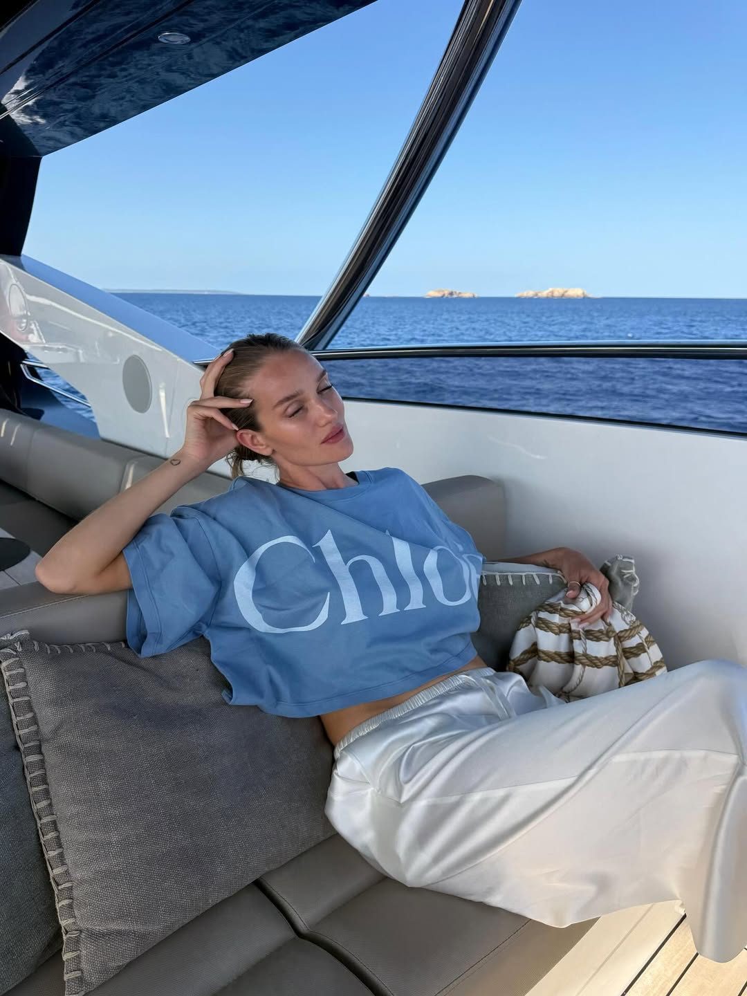 Rosie Huntington-Whiteley wearing Chloe Boxy logo Airy blue t-shirt and SNDYS Dove white pant.
