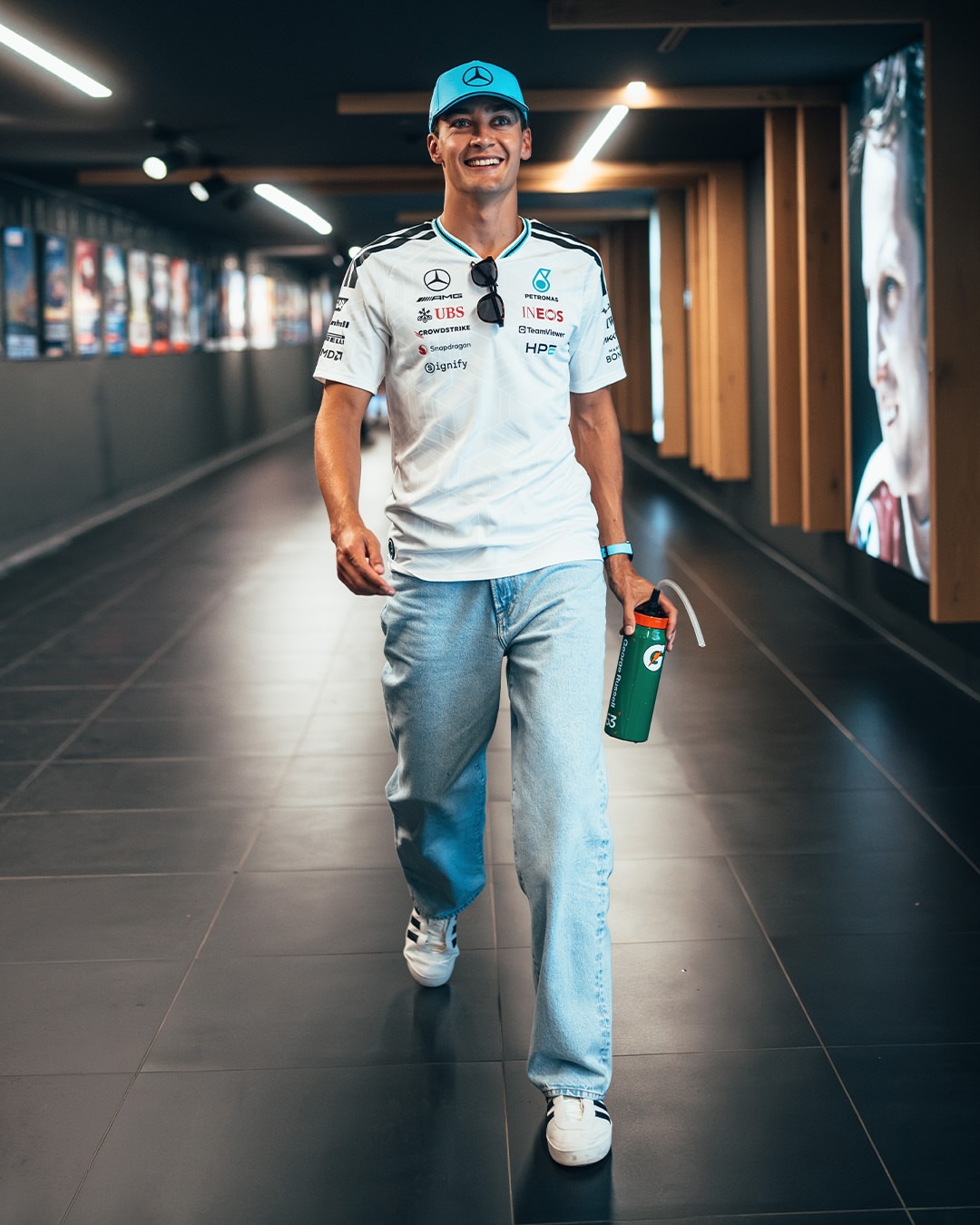 George Russell wearing Adidas Mercedes – amg petronas formula 1 team driver jersey white, Levi’s 568Tm loose linen+ denim men’s jeans Light.