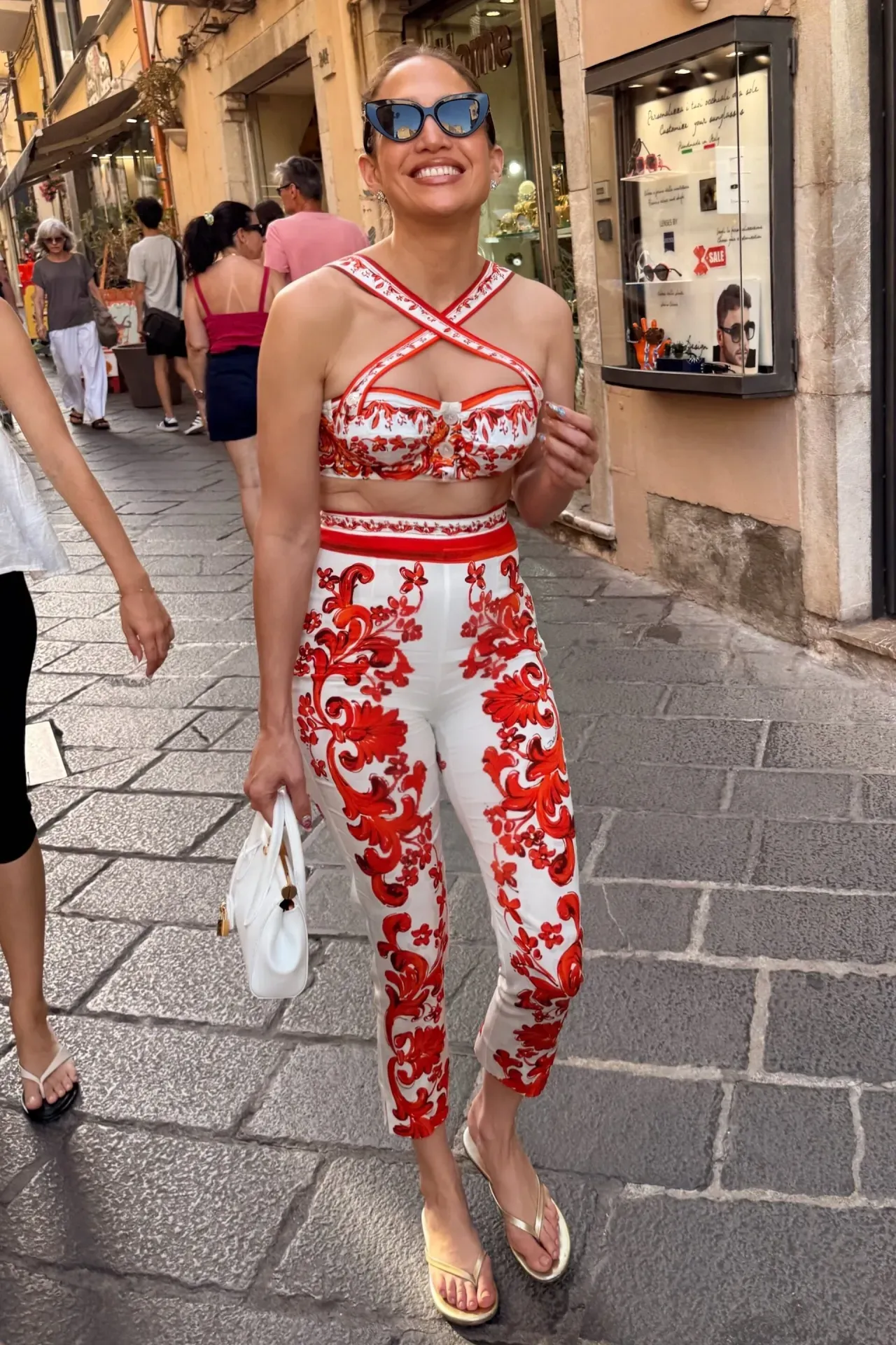 Jennifer Lopez wearing Dolce & Gabbana Majolica-print poplin bustier top white and red, Dolce & Gabbana Majolica-print charmeuse leggings and Solei.