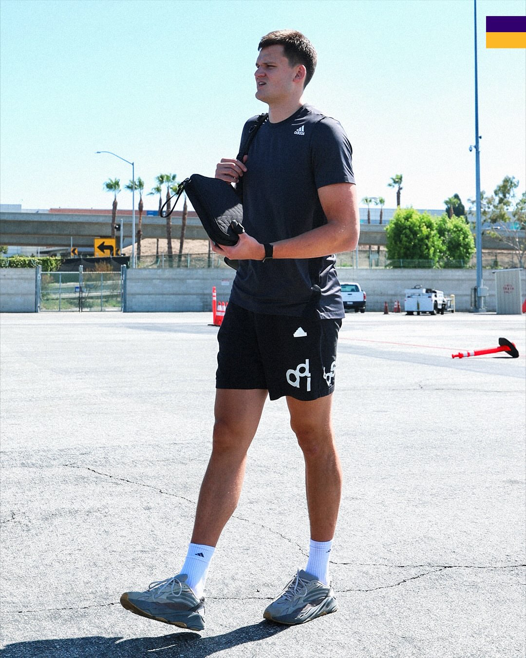 Walker Kessler wearing adidas Train essentials training tee, adidas Graphic print shorts and adidas Yeezy Boost 700 v2 sneakers Grey.