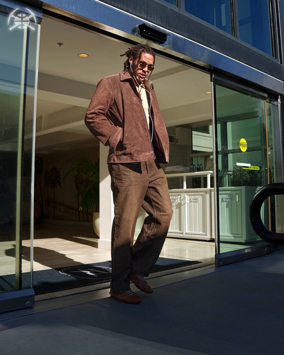 Aaron Gordon wearing All Saints Rhone suede jacket cocoa brown, The Row Siouxie wide-leg jeans brown cocoa and Prada Montecarlo re-edition 2005 sneakers black.