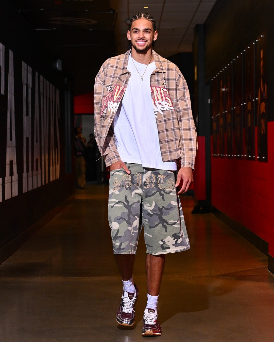 Asa Newell wearing Fashion Nova Revenge Woven Flannel beige, Fashion Nova Relaxed Saints Embellished Camo Denim Shorts and Bottega Veneta Men’s orbit.