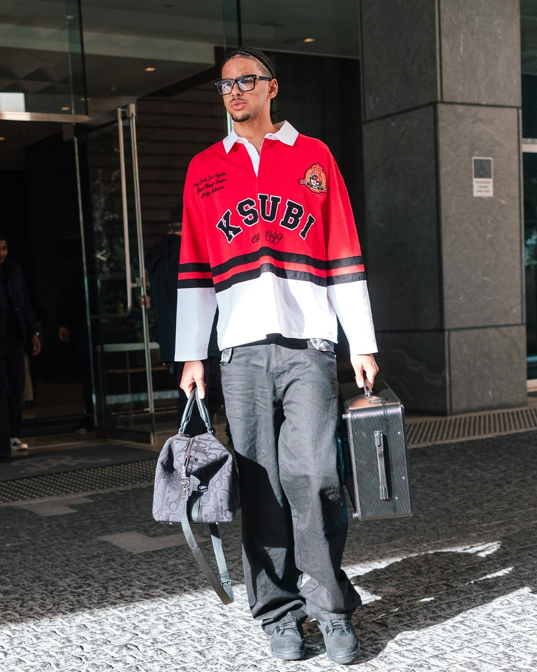 Asa Newell wearing Ksubi Ksubi Duke Rugby Jersey ‘Red’, Dior Dior jett weekender bag black and Air Jordan Air Jordan 4 Retro ‘Black.
