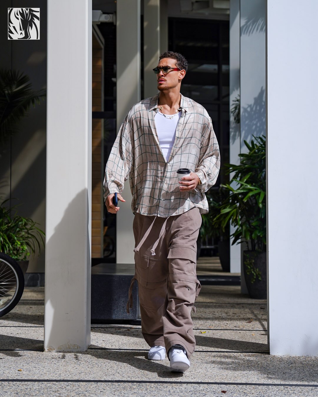 Dwight Powell wearing Acne Studios Pink checkered shirt pink and green, Rick Owens Gray tower stefan cargo pants and Nike Nike Air Force 1 ’07 white.