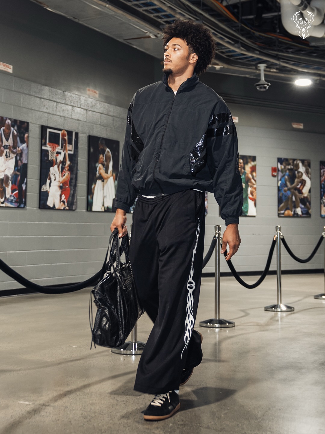 Dylan Harper wearing Vetements Tape-detail tracksuit jacket black, Balenciaga 2024 Burning Unity Joggers black and Maison Margiela Replica sneakers black.