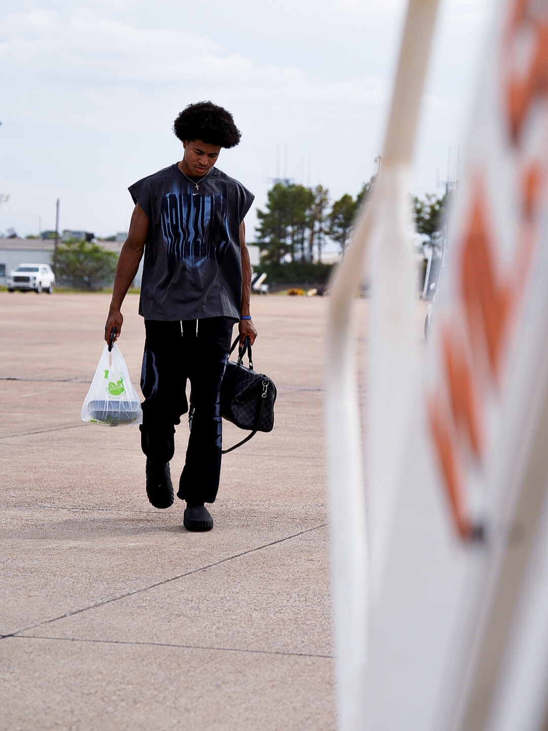 GG Jackson wearing Nike Men’s memphis grizzlies nike charcoal 2026 standard issue pre-game sleeveless top, Gallery Dept. Dept post track pants black and.