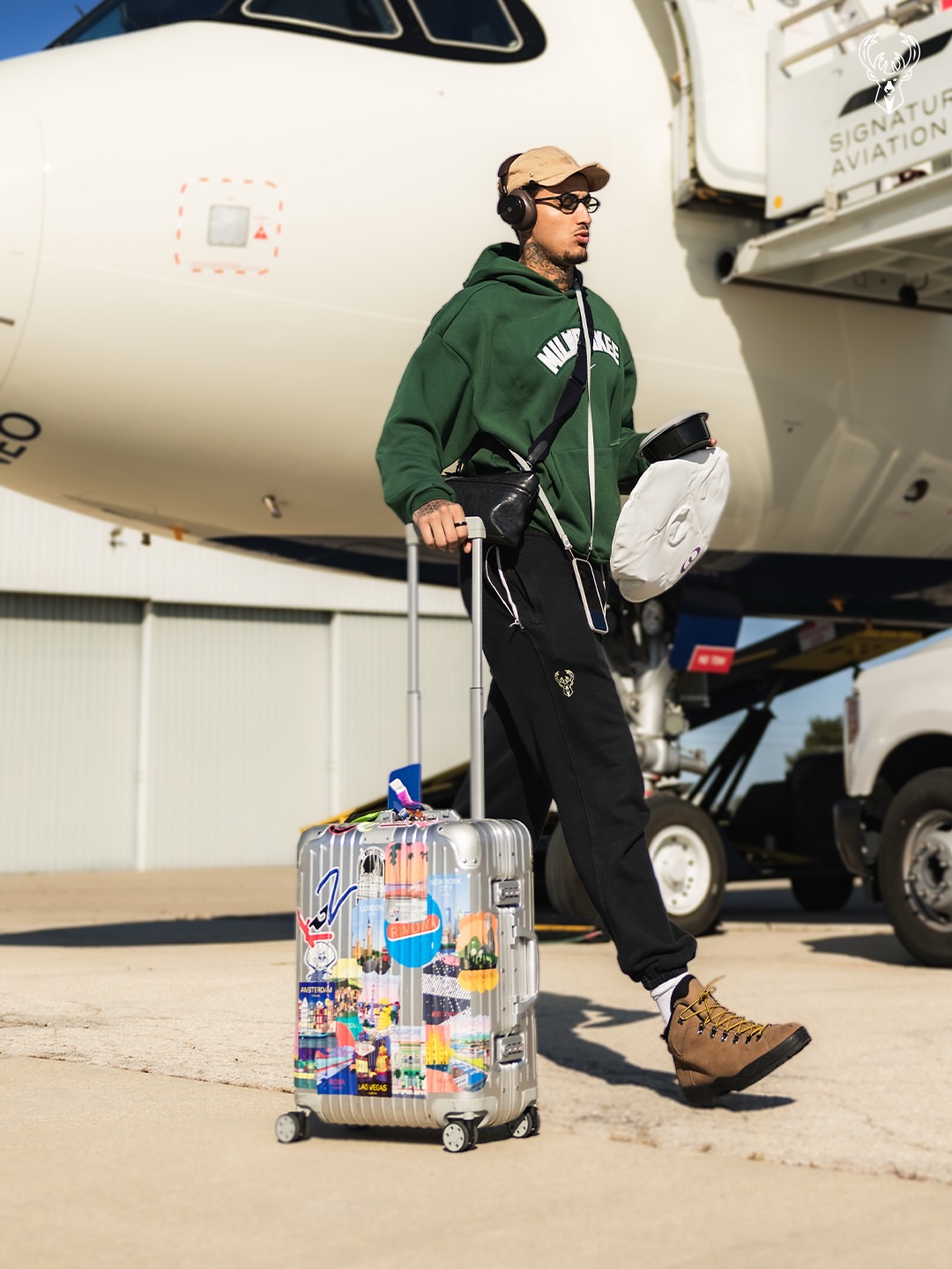 Kyle Kuzma wearing Nike Milwaukee Bucks City Edition, NBA Store Pro standard first team milwaukee bucks jogger sweatpants and Danner Mountain light wallowa.